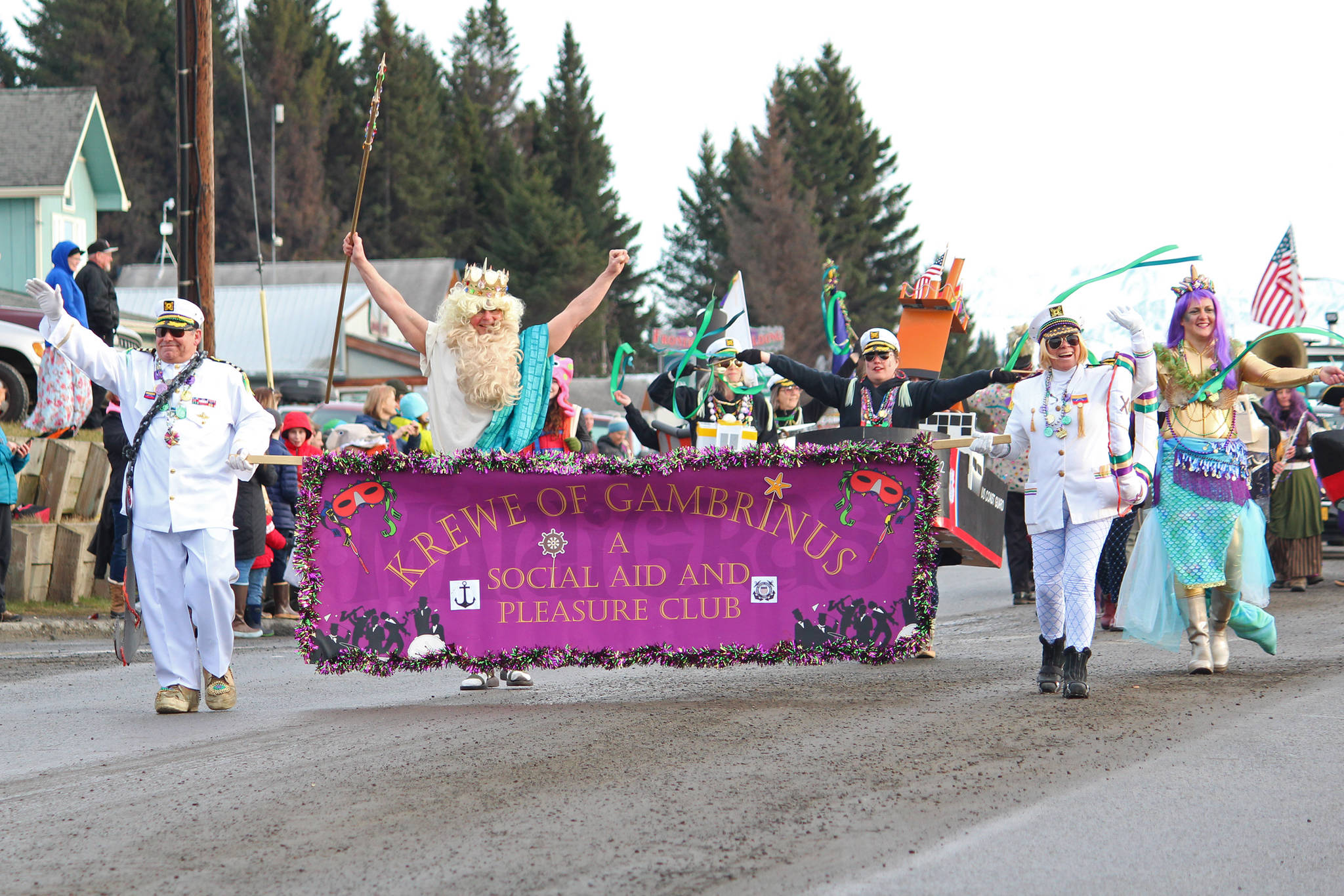Members of the Krewe of Gambrinus march down Pioneer Avenue on Saturday, Feb. 9, 2019 during the Winter Carnival Parade in Homer, Alaska. (Photo by Megan Pacer/Homer News)