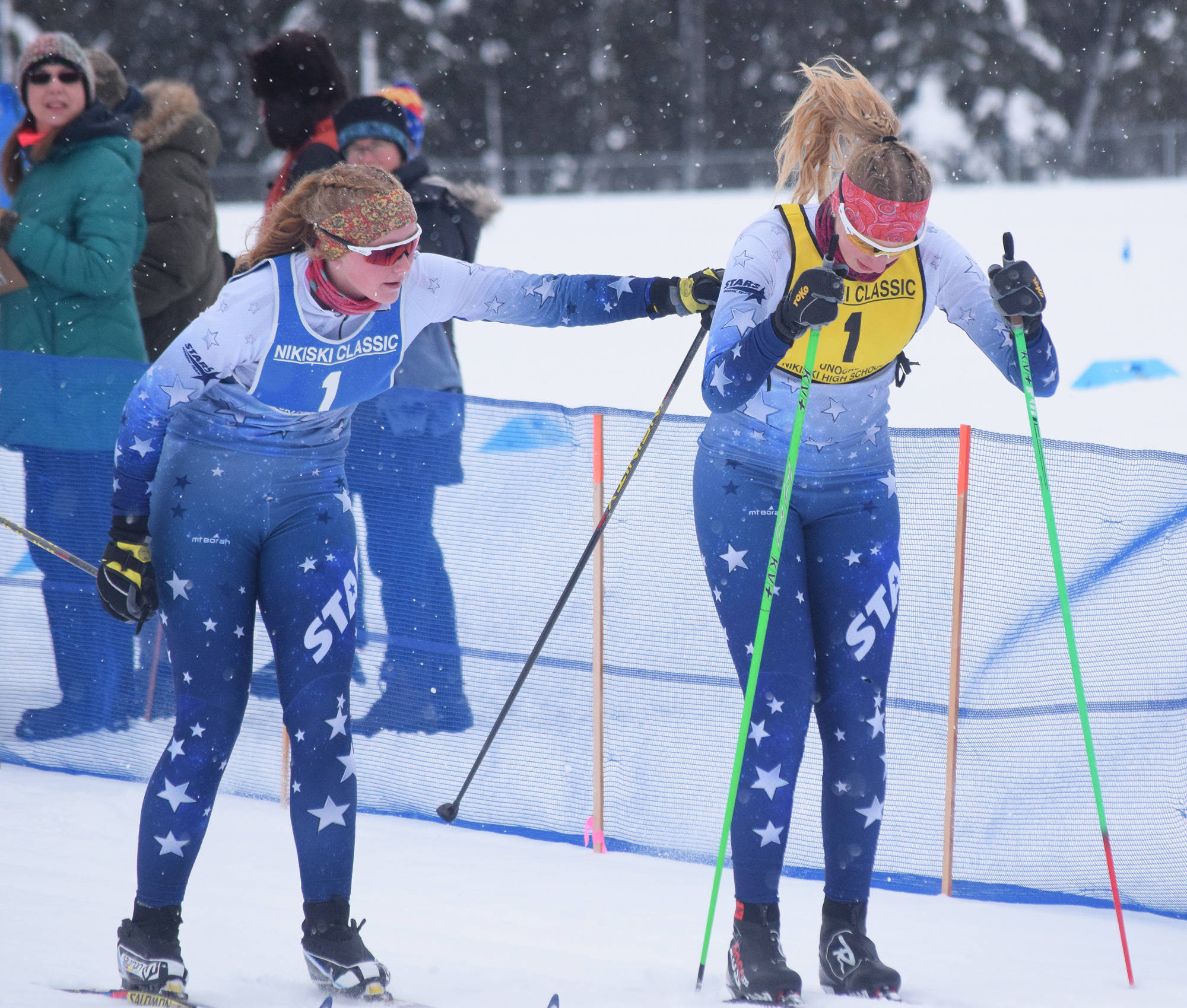 Soldotna’s Sonora Martin (left) tags off to teammate Cameron Blackwell in a relay race Saturday afternoon at the Kenai Peninsula Borough nordic ski meet at the Tsalteshi Trails in Soldotna. (Photo by Joey Klecka/Peninsula Clarion)