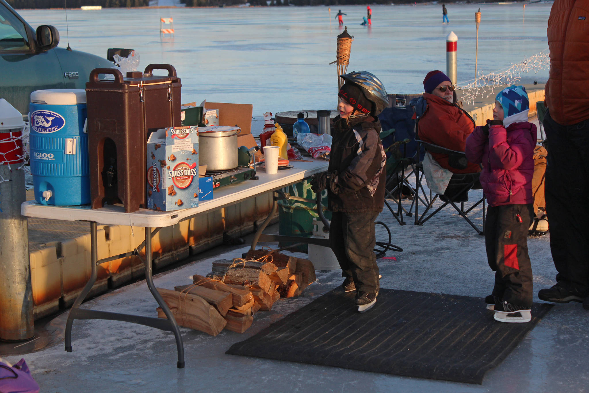 Some youngsters eye the hot chocolate and other offerings at a free ice skating party hosted by Rotary Club of Homer-Kachemak Bay, McDonalds and the City of Homer on Friday, Feb. 15, 2019 at Ben Walters Park and Beluga Lake in Homer, Alaska. (Photo by Megan Pacer/Homer News)