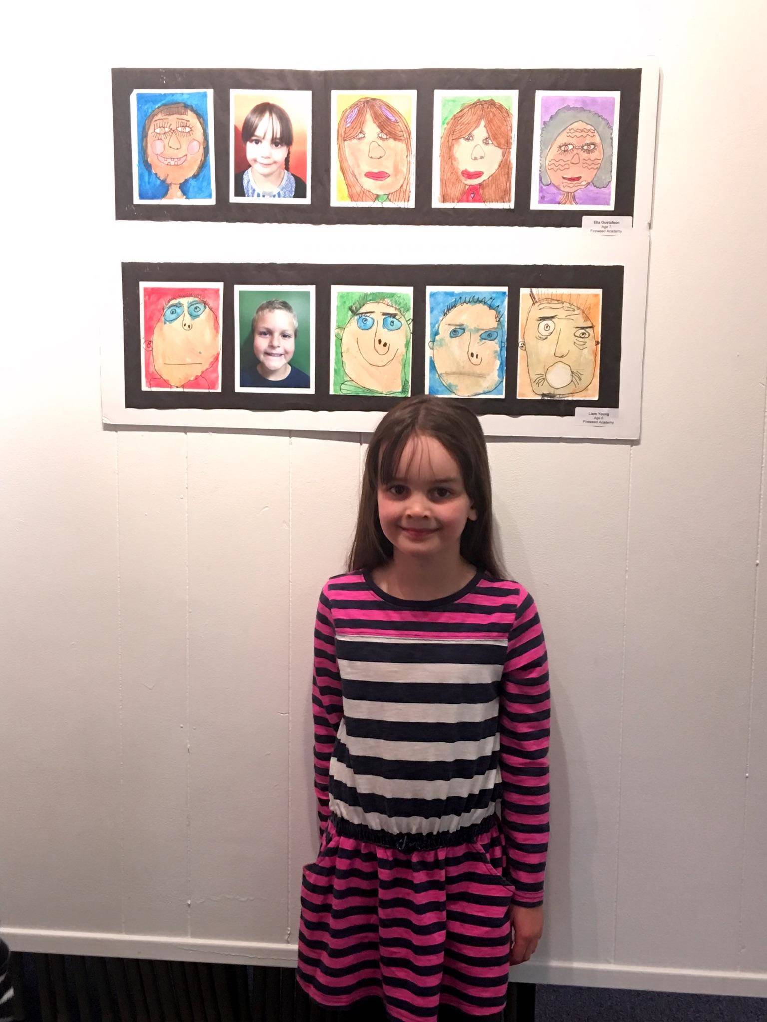 Ella Gustafson stands by a display of student art at a past Jubilee show at the Homer Council on the Arts. (Photo provided)