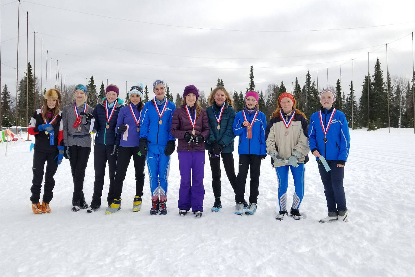 The top ten girl skiers from Homer Middle School pose for a photo at a borough-wide ski meet the weekend of March 2-3, 2019 in Kenai, Alaska. (Photo submitted)