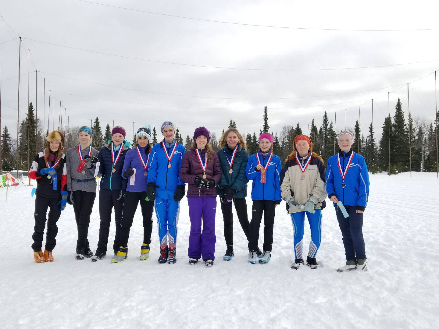 The top ten girl skiers from Homer Middle School pose for a photo at a borough-wide ski meet the weekend of March 2-3, 2019 in Kenai, Alaska. (Photo submitted)