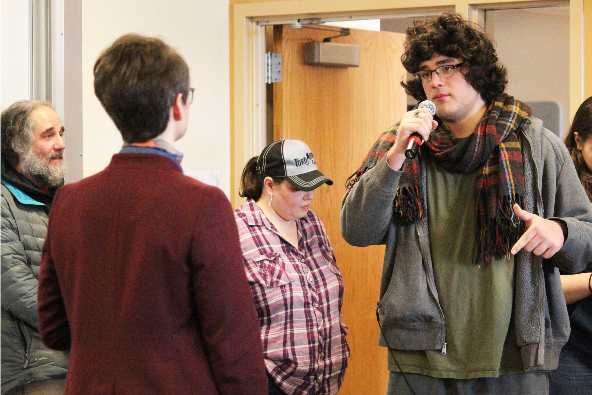 Jesse Roach, a senior at Homer High School, speaks to Rep. Sarah Vance (R-Homer) about the effects of cuts to education at a town hall meeting Saturday, March 2, 2019 at Kachemak Bay Campus in Homer, Alaska. Roach referenced his own experience in the Oklahoma education system after it experienced deep cuts. (Photo by Megan Pacer/Homer News)