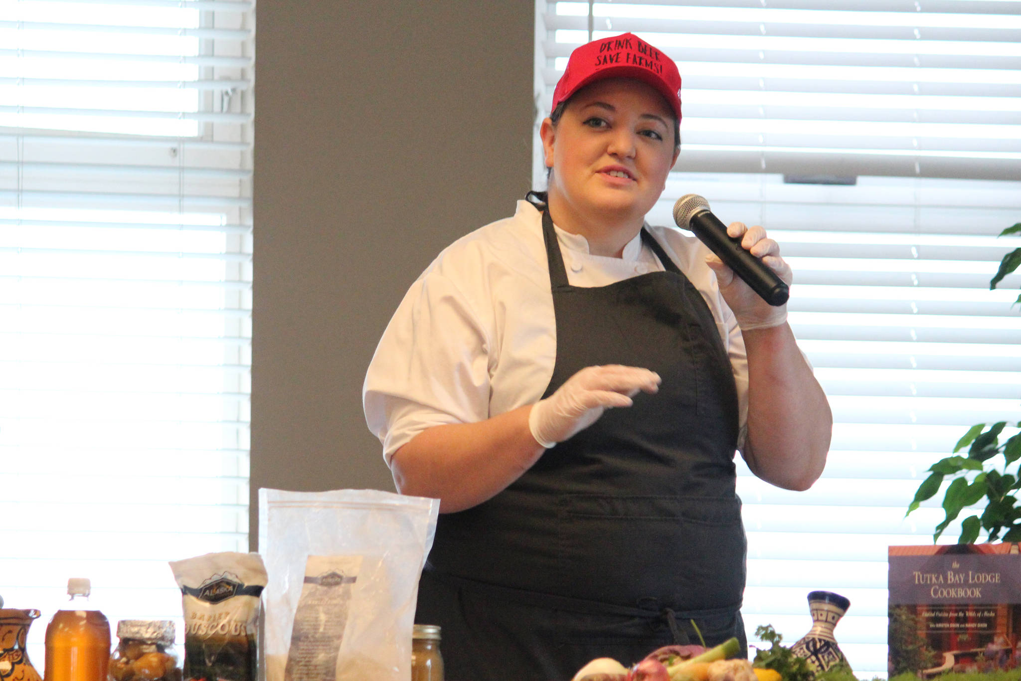 Mandy Dixon, owner of La Baleine, speaks during a cooking demo during the Alaska Food Festival on Saturday, March 9, 2019 at Land’s End Resort in Homer, Alaska. She and her mother, Kirseten, who owns Tutka Bay Lodge, spoke about their travels to other countries and how that inspires their cooking in Alaska. (Photo by Megan Pacer/Homer News)