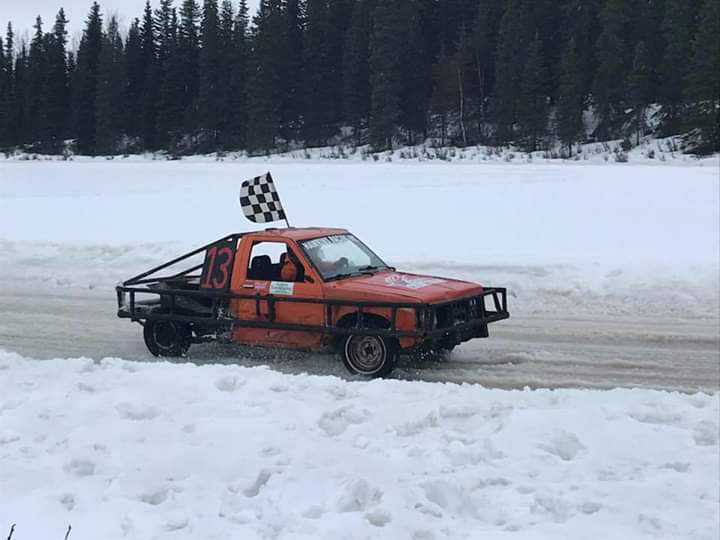 Photo provided by Kenai Peninsula Ice Race Association                                 Owner/driver JT Hawkins in his #13 car sporting the checkered flag.