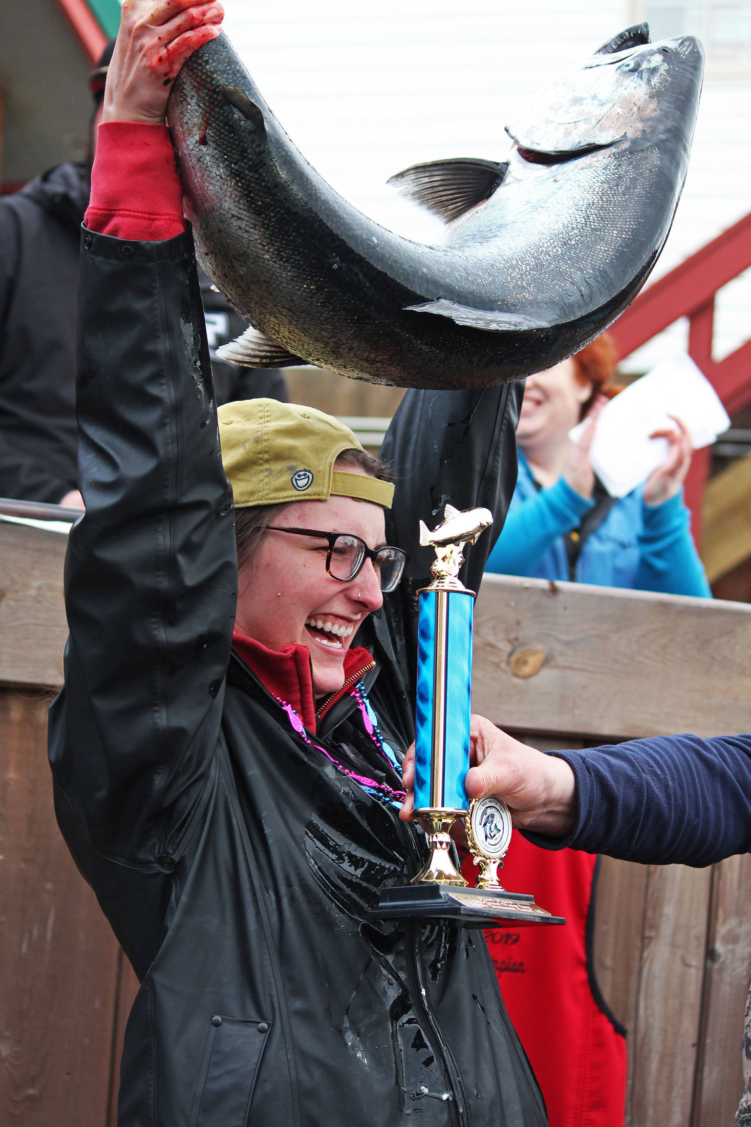 Shayna Perry, of Eagle River, holds up her winning 26.7-pound white salmon at the award ceremony following the Homer Winter King Salmon Tournament on Saturday, March 23, 2019 at Coal Point Seafoods in Homer, Alaska. Perry, who also won the award for largest white salmon, is the first woman to win the annual tournament. (Photo by Megan Pacer/Homer News)