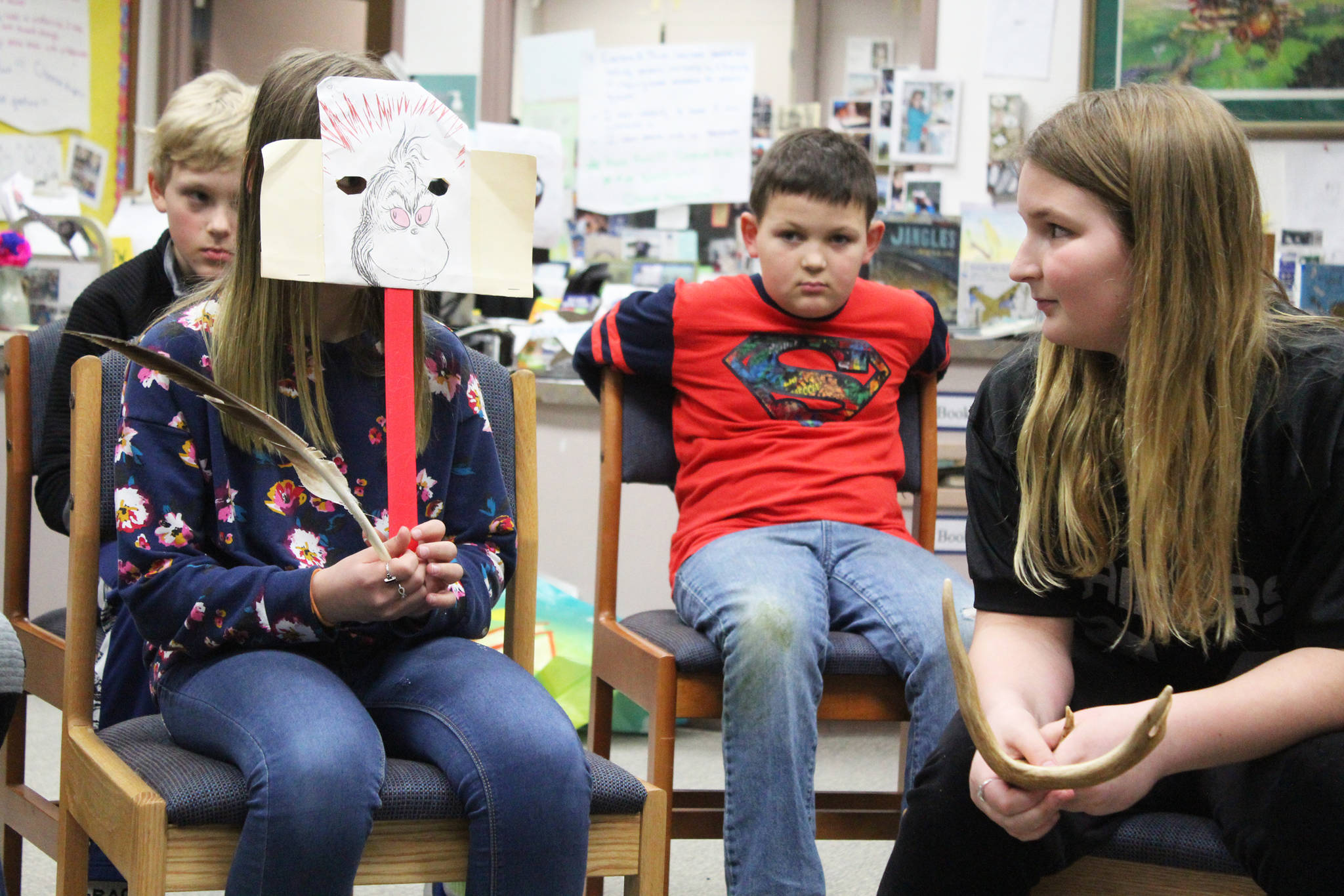 Synnove Neese, left, and Kaiah Stineff, right, act out a restorative justice scenario involving the characters from The Grinch on March 22, 2019 at West Homer Elementary School in Homer, Alaska. Fifth and sixth graders at the school are partaking in a new restorative justice program through the already existing Youth Court program. (Photo by Megan Pacer/Homer News)