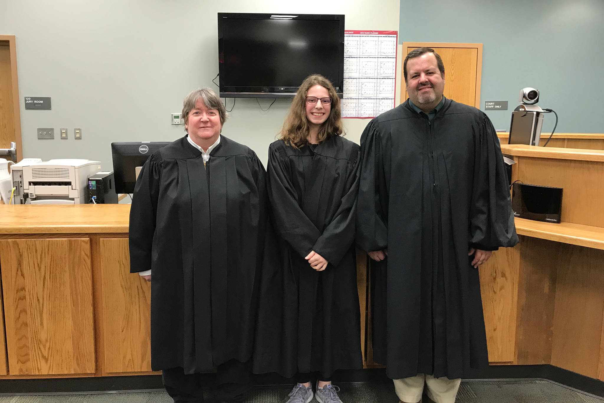 District Court Judge Margaret Murphy (left) and Superior Court Judge is Jason Gist (right) celebrate Rainey Sundheim during a Kenai Peninsula Youth Court swearing-in ceremony on March 27, 2019 at the Homer Courthouse in Homer, Alaska. (Photo courtesy Becky Paul)