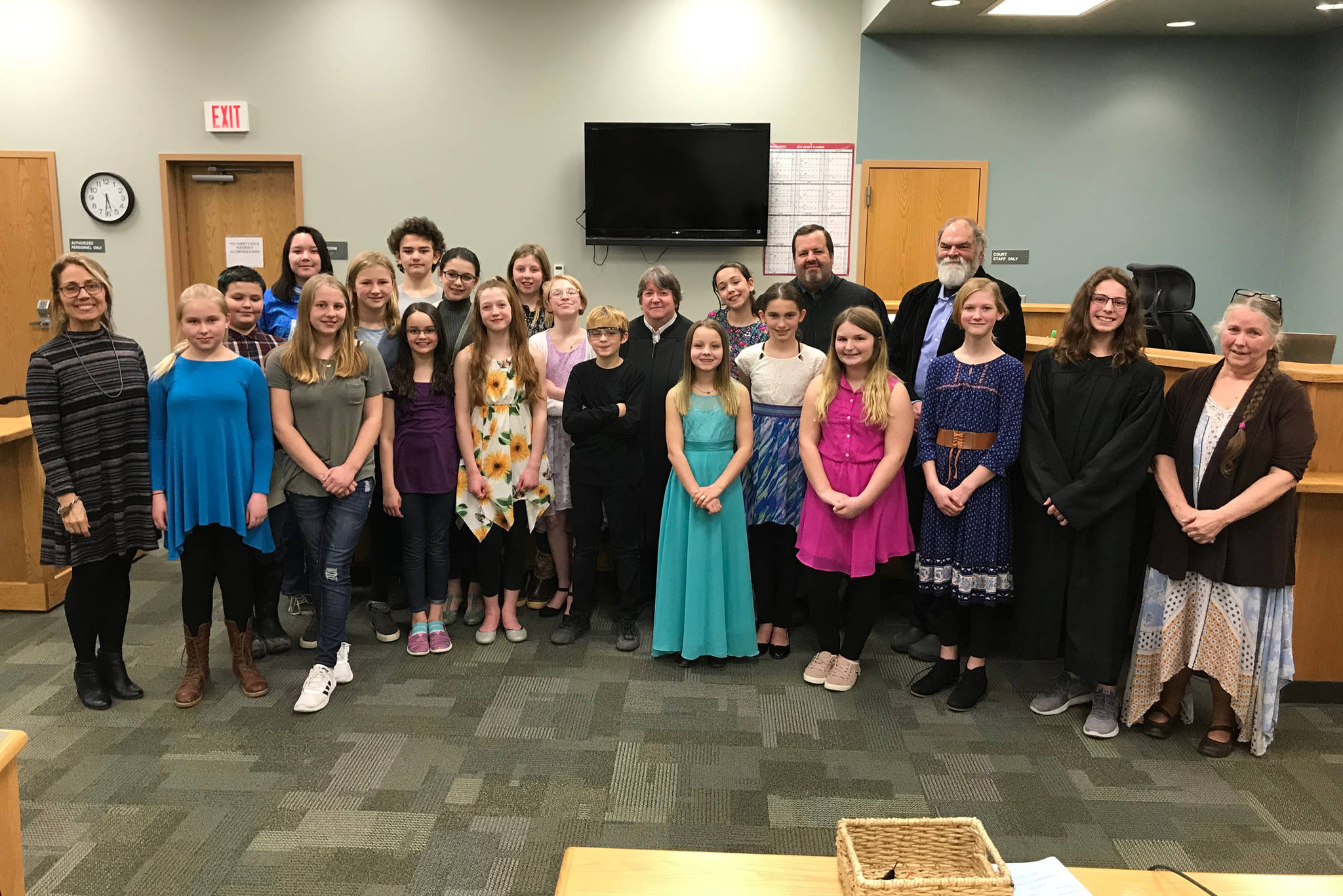 West Homer Elementary School teacher Becky Paul (far left), Superior Court Judge is Jason Gist (back), Homer Mayor Ken Castner (back, right), and Kenai Peninsula Youth Court Director Ginny Espenshade (far right) celebrate students from the school during a swearing-in ceremony on March 27, 2019 at the Homer Courthouse in Homer, Alaska. (Photo courtesy Becky Paul)