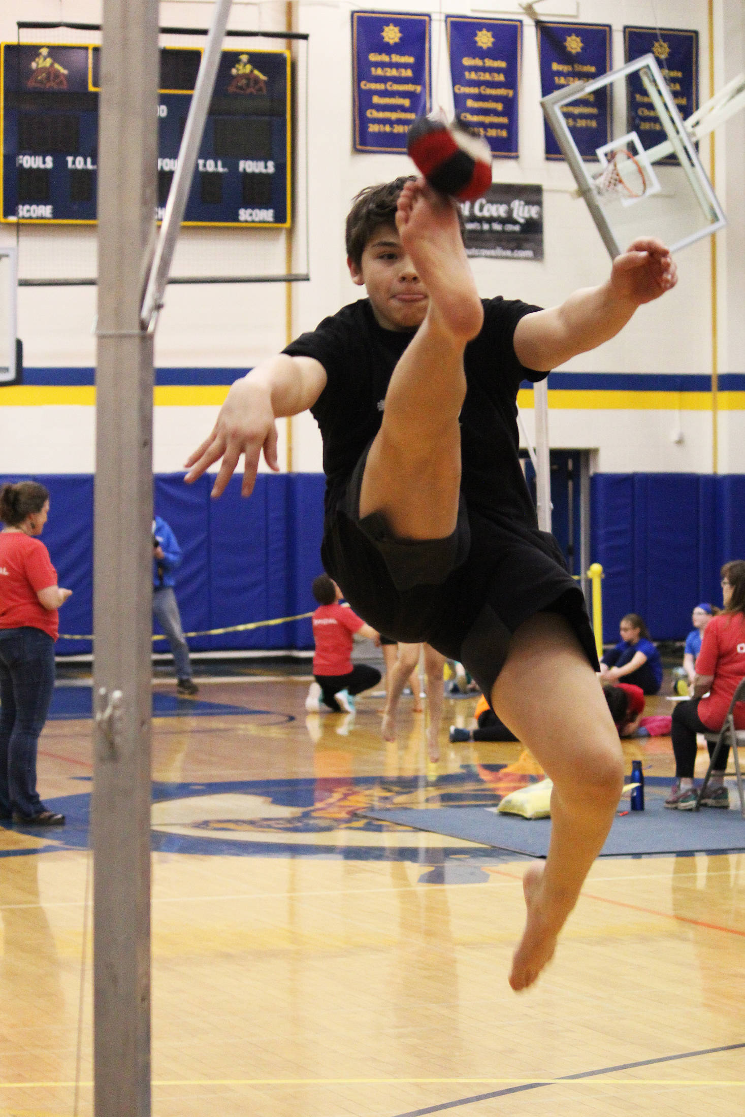 William Wilson, 13, performs the one-foot high kick Saturday, March 30, 2019 during the Kachemak Bay Traditional Games held at Homer High School in Homer, Alaska. (Photo by Megan Pacer/Homer News)