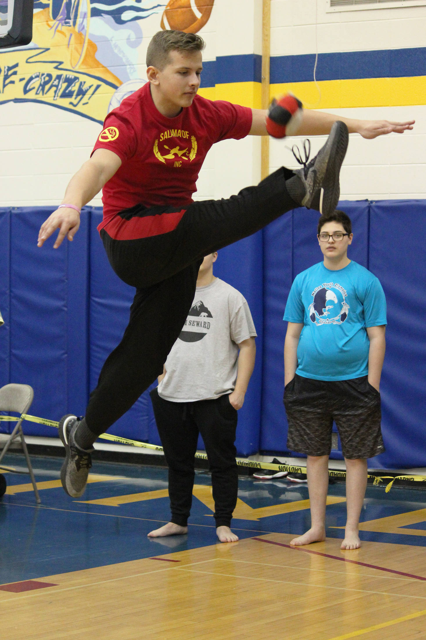 Judah Gason, 16, competes in the one-foot high kick event Saturday, March 30, 2019 during the Kachemak Bay Traditional Games invitational at Homer High School in Homer, Alaska. (Photo by Megan Pacer/Homer News)