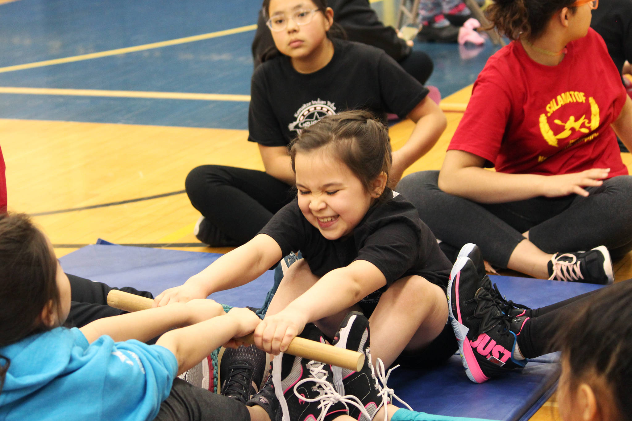 Sonya Ivanoff, 8, participates in the Eskimo Stick Pull during the Kachemak Bay Traditional Games invitational Saturday, March 30, 2019 at Homer High School in Homer, Alaska. (Photo by Megan Pacer/Homer News)
