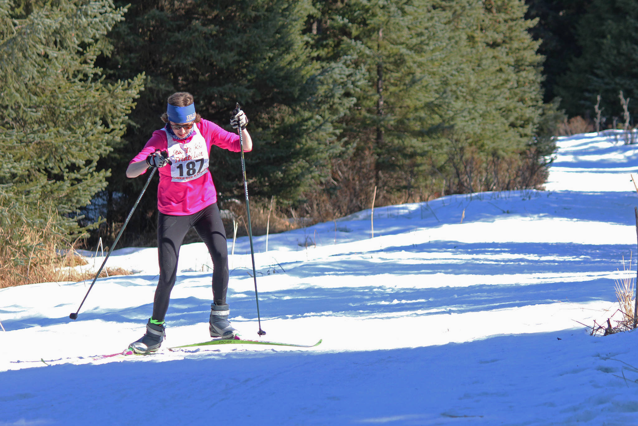 Tamra Kornfield skis to the finish line of the Sea to Ski Triathlon to win first place in the Ironwoman category Sunday, March 31, 2019 in Homer, Alaska. (Photo by Megan Pacer/Homer News)