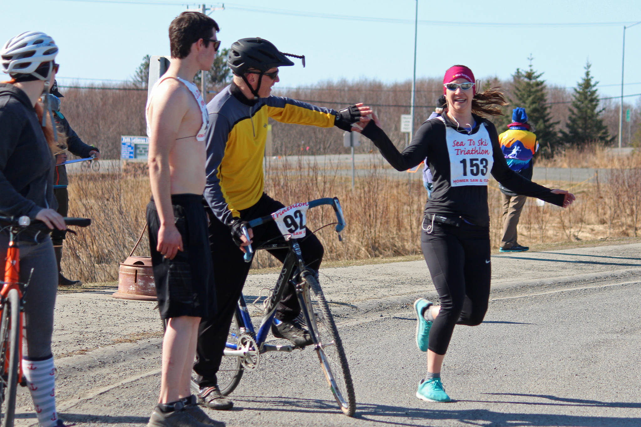 A runner tags her teammate after the first leg of the Sea to Ski Triathlon on Sunday, March 31, 2019 in Homer, Alaska. (Photo by Megan Pacer/Homer News)