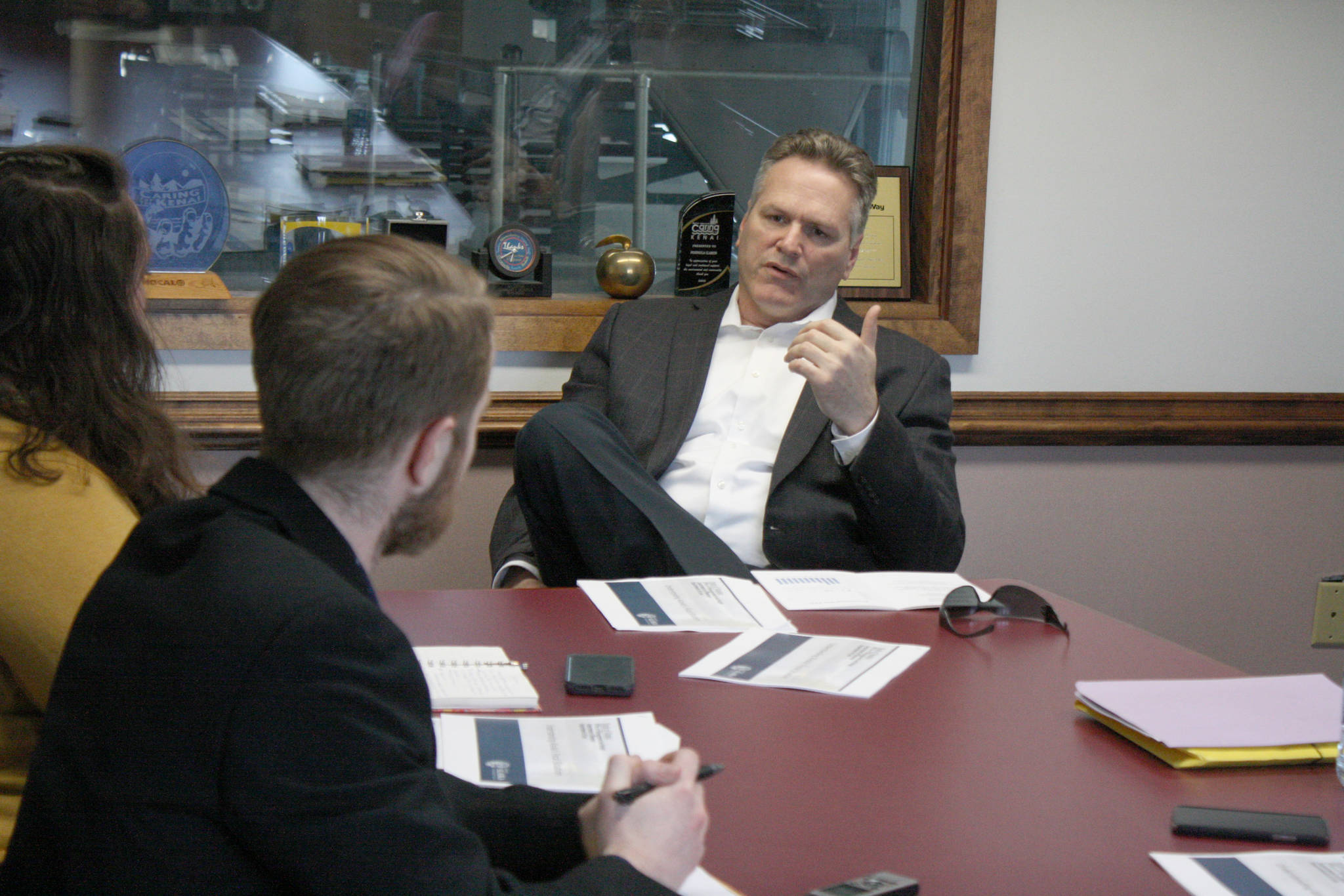 Gov. Mike Dunleavy speaks with Clarion reporters Brian Mazurek, left, and Victoria Petersen on Monday, March 25, 2019 in Kenai, Alaska. The governor answered questions on a wide range of topics, including public safety, education, industry and his proposed budget. (Photo by Erin Thompson/Peninsula Clarion)