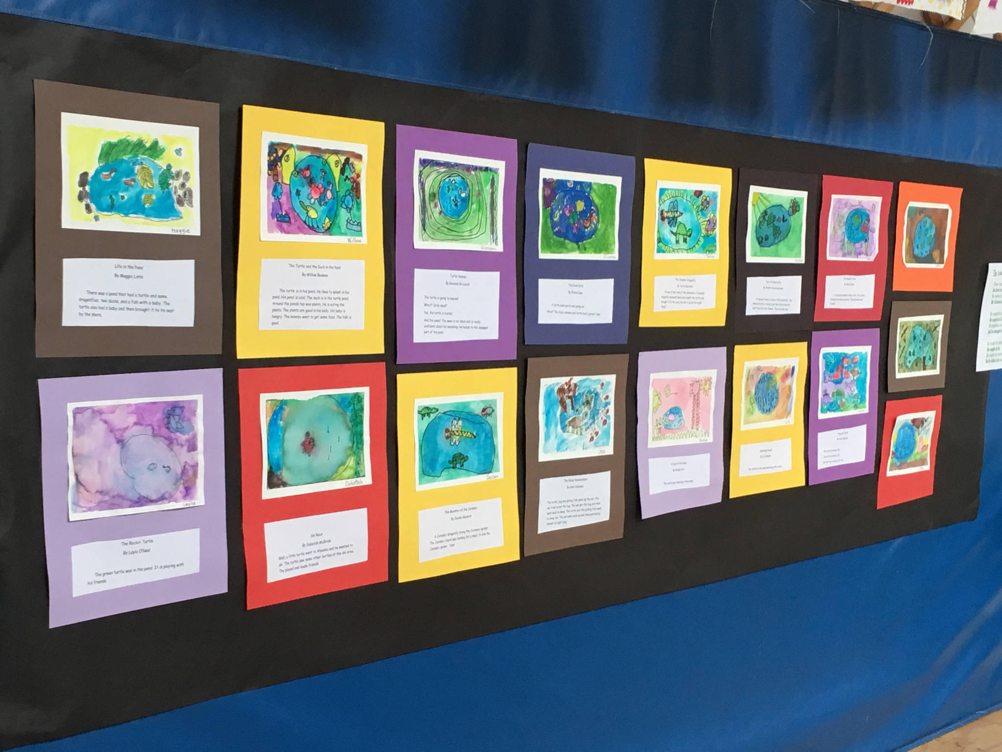 Artwork by students at Fireweed Academy line the wall on Friday, March 29, 2019 at the end of an art residency by Debbie Piper at Little Fireweed in Homer, Alaska. (Photo courtesy Adele Person)