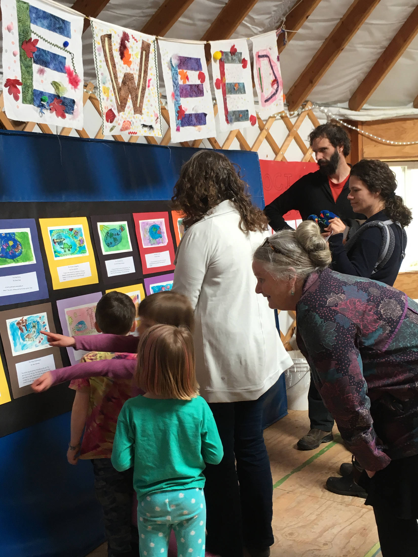 Students and family members review art students made during a residency by Debbie Piper, during an art showing Friday, March 29, 2019 at Little Fireweed Academy in Homer, Alaska. (Photo courtesy Adele Person)