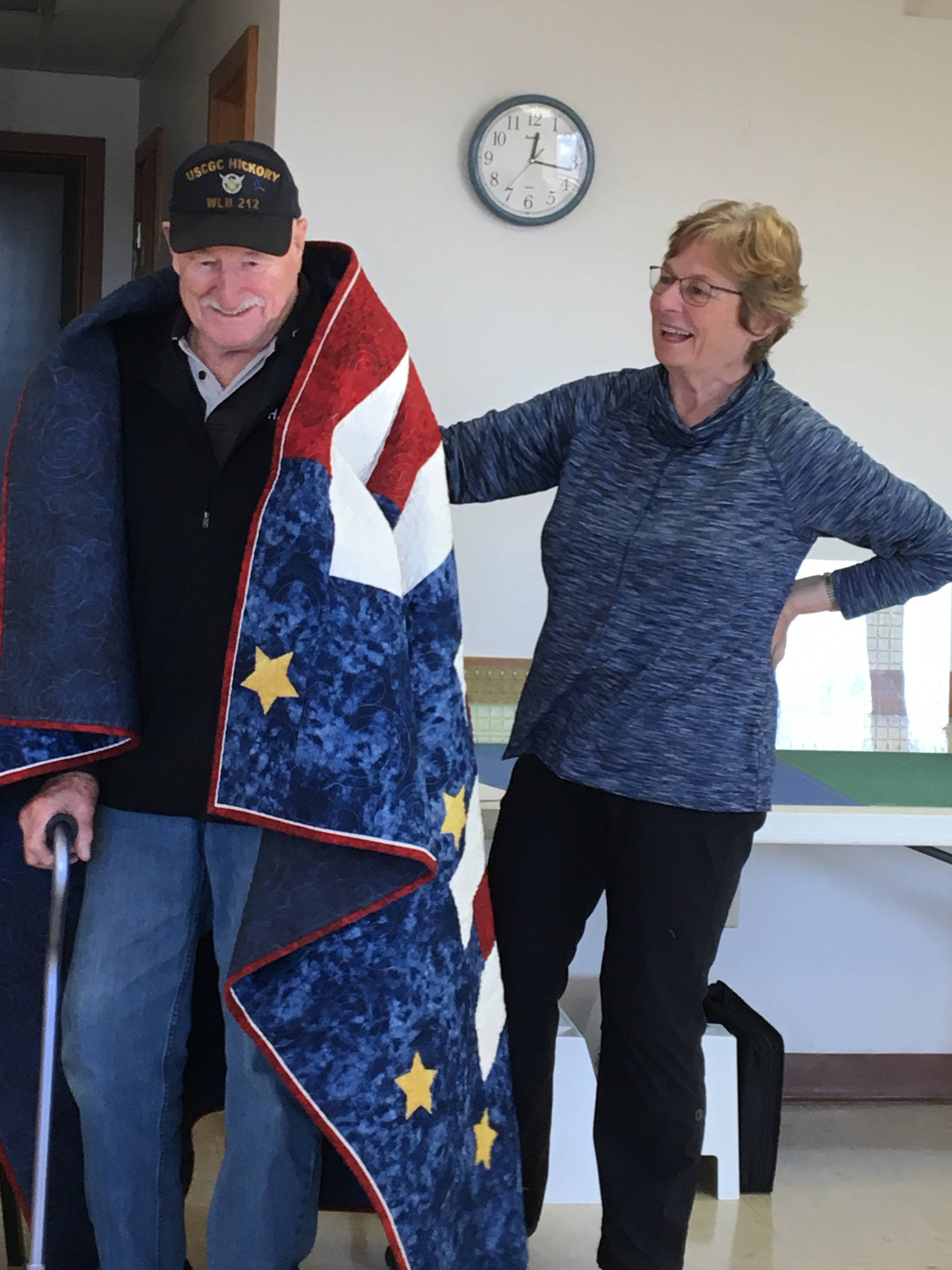 Lorraine Murphy, right, presents Sandy Mazen with a Quilt of Valor made by Kachemak Bay Quilters on April 4, 2019, at at Kachemak Community Center in Kachemak City, Alaska. (Photo provided)