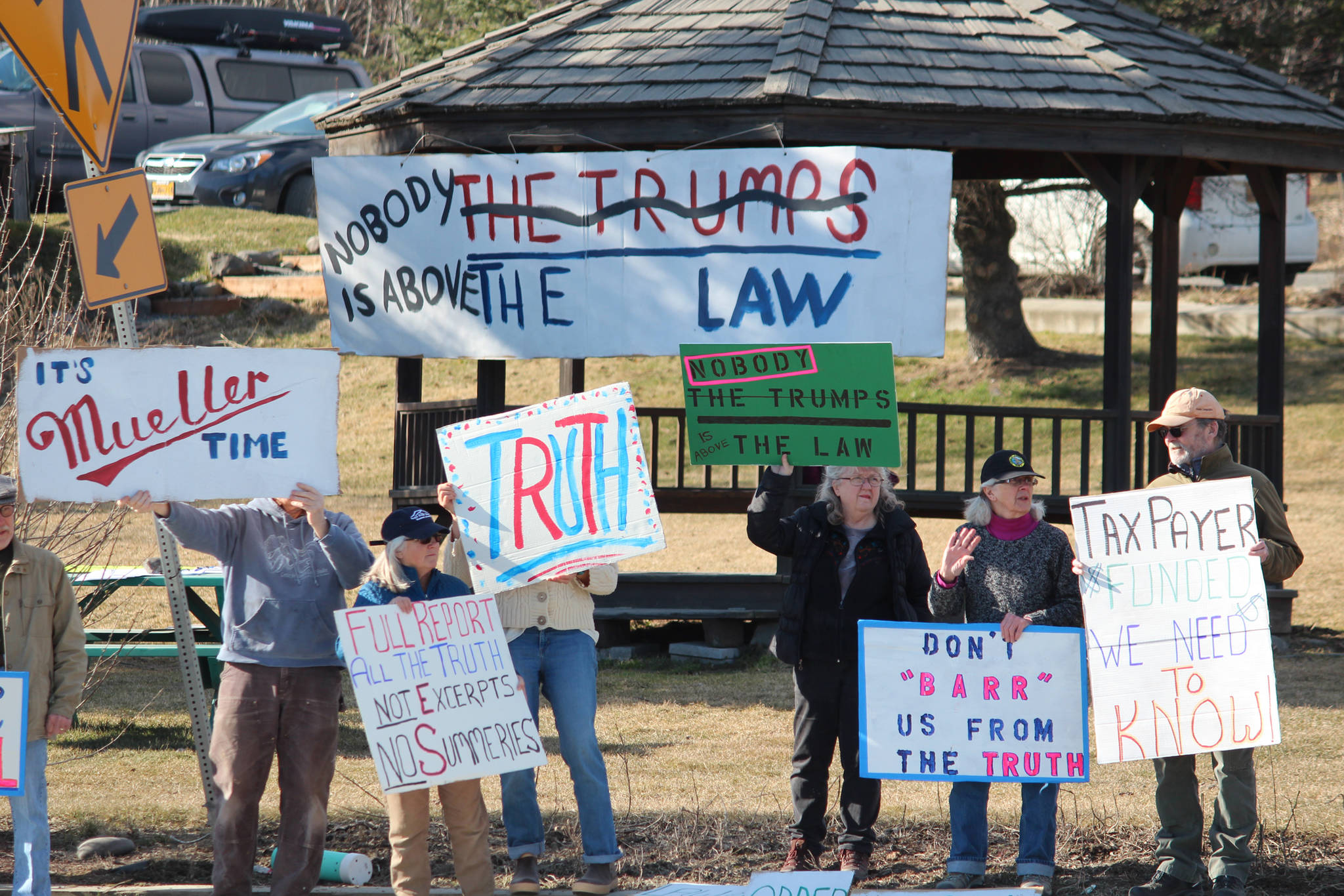 Local demonstrators stand at WKFL Park on Thursday, April 4, 2019 in Homer, Alaska, joining protests done nationally to prompt the release of special counsel Robert Mueller’s report of his investigation into Russian interference in the 2016 United States presidential election. (Photo by Megan Pacer/Homer News)