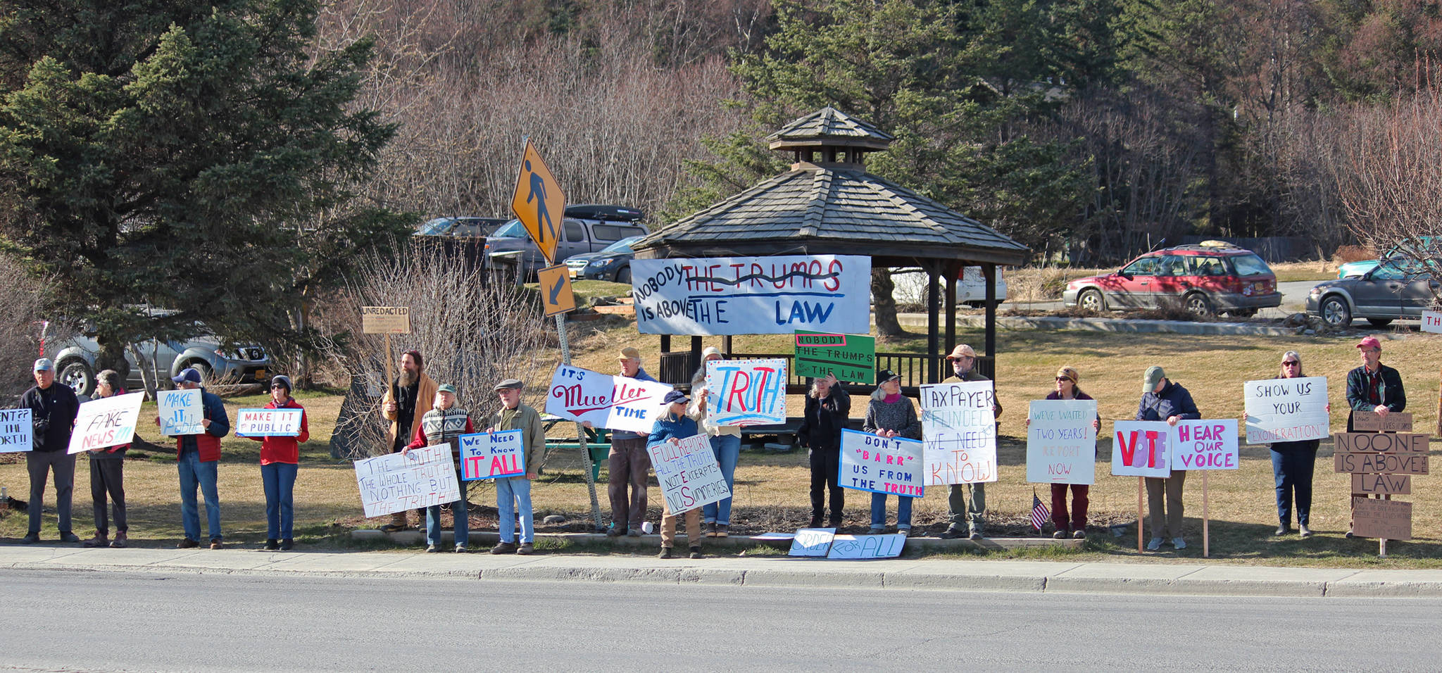 Local demonstrators stand at WKFL Park on Thursday, April 4, 2019 in Homer, Alaska, joining protests done nationally to prompt the release of special counsel Robert Mueller’s report of his investigation into Russian interference in the 2016 United States presidential election. (Photo by Megan Pacer/Homer News)