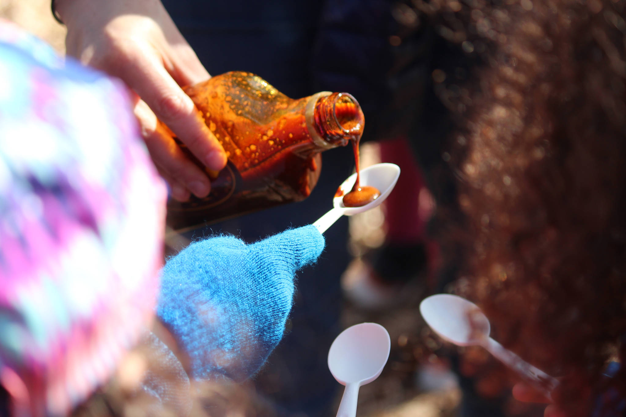 First grade students from Paul Banks Elementary School line up for a taste of Bridge Creek Birch Syrup during a Friday, April 12, 2019 field trip to the grove where the company taps for sap off East End Road in Homer, Alaska. (Photo by Megan Pacer/Homer News)