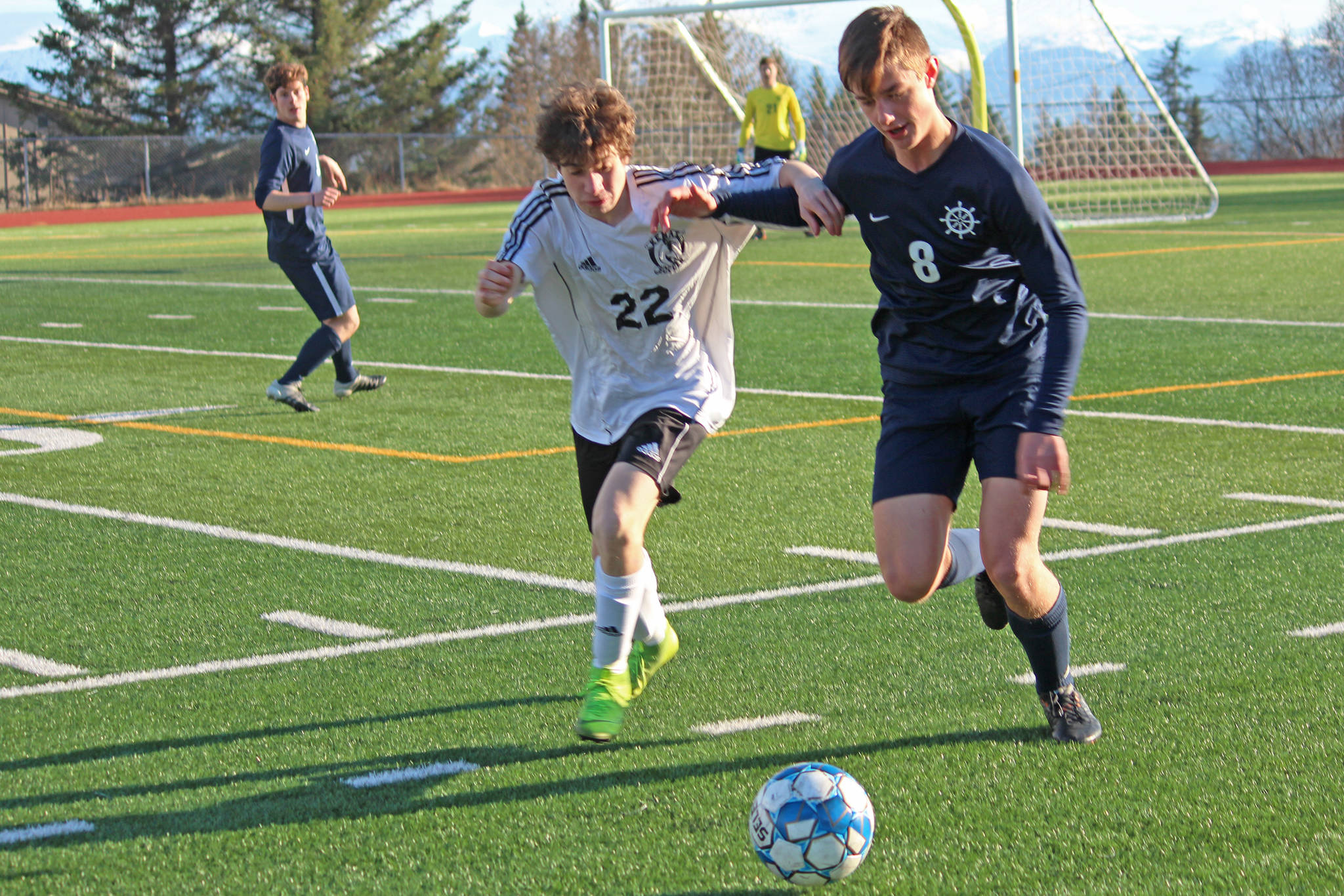 Homer’s Clayton Beachy fights with Kenai’s Francisco Garmen Munarriz for possession of the ball during a Tuesday, April 16, 2019 game at Homer High School in Homer, Alaska. (Photo by Megan Pacer/Homer News)