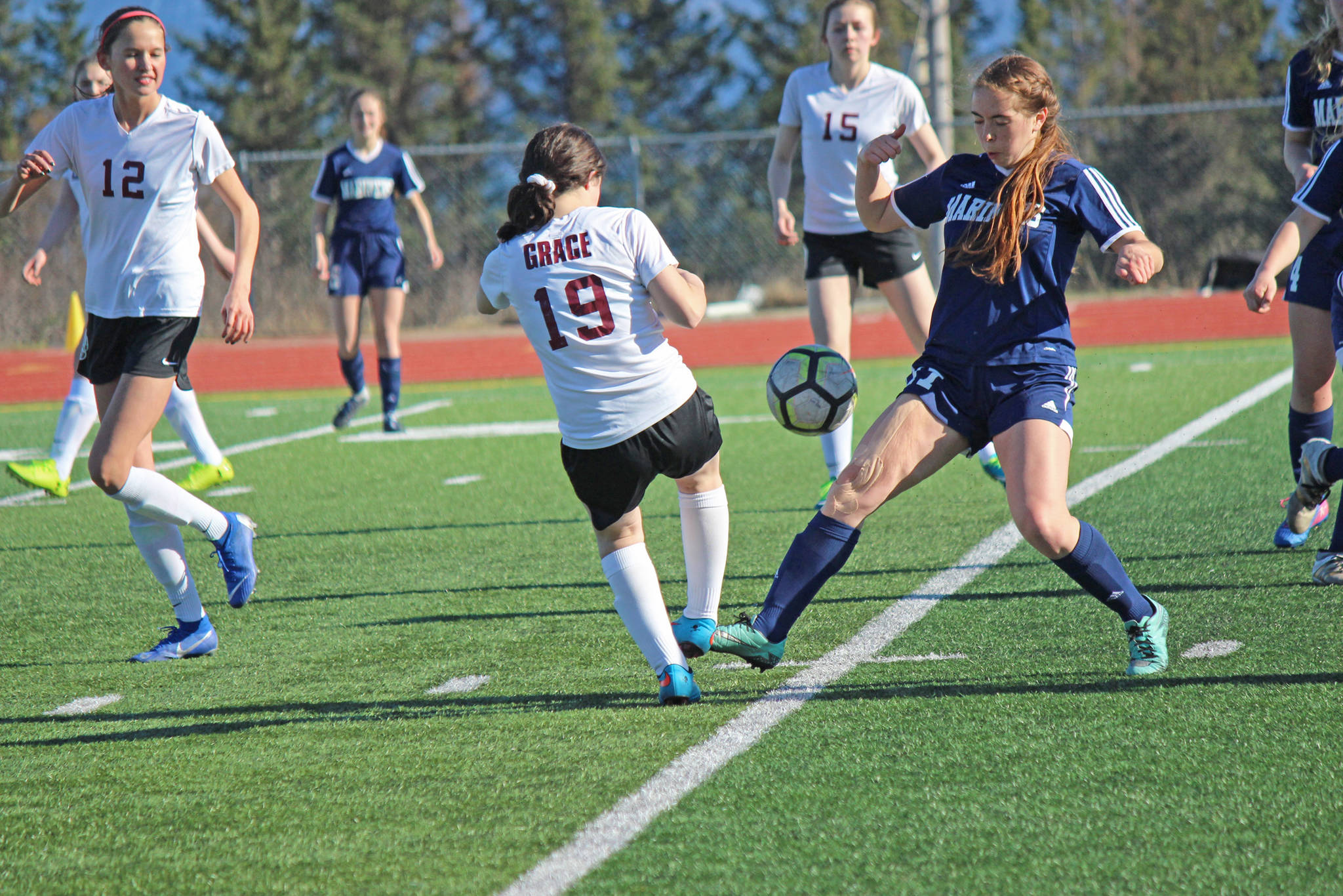 Mariner Summer McGuire has no intention of giving up control of the ball during Friday’s varsity soccer game against Grace Christian on April 26, 2019, at the high school in Homer, Alaska. (Photo by McKibben Jackinsky)