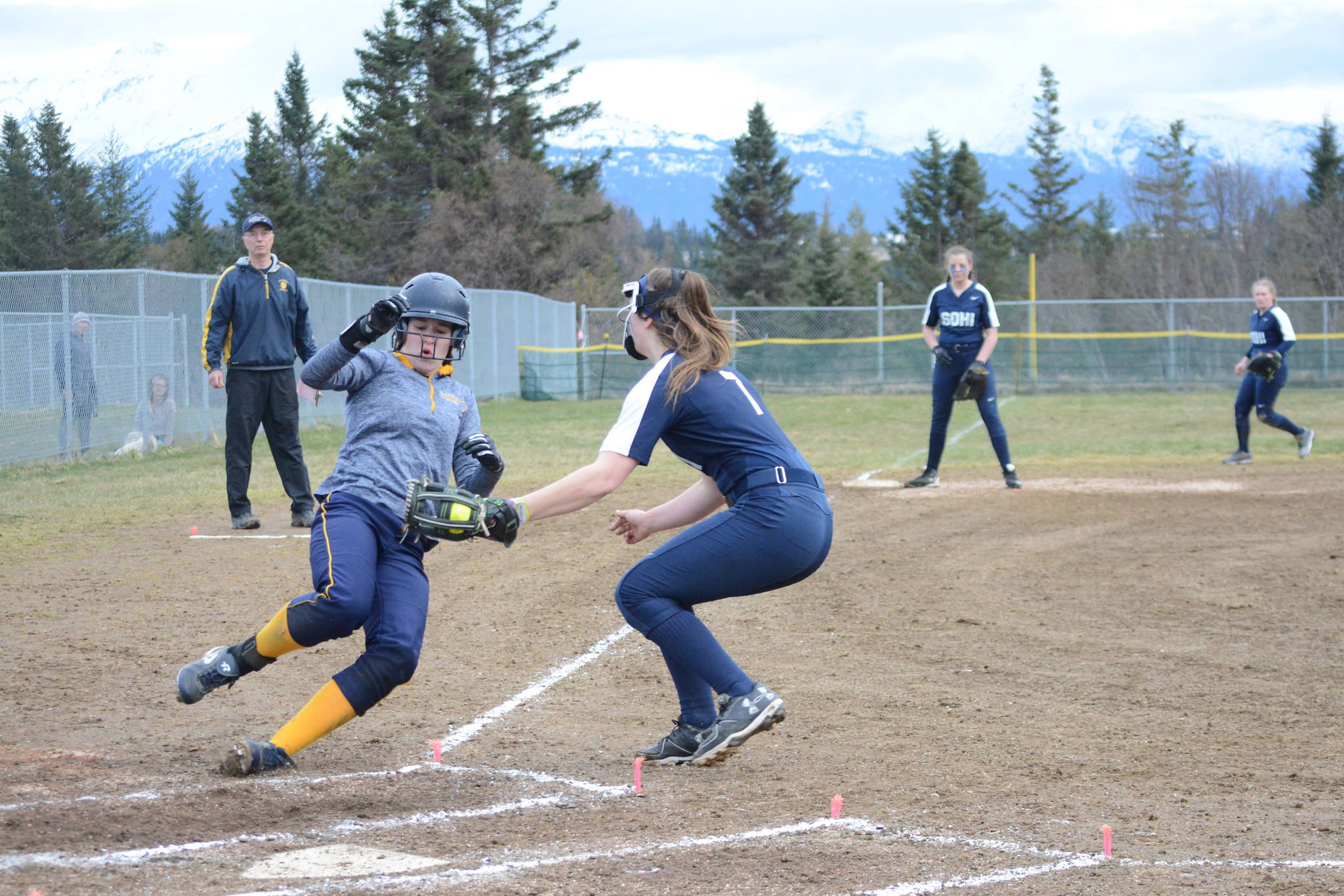 SoHi softball catcher Casey tags out Homer High School Mariner Grace Godfrey as she tries for home plate in a game against the Homer High School Mariners on Tuesday, April 30, 2019, at Jack Gist Park in Homer, Alaska. Godfrey later redeemed herself with a grand slam home run. (Photo by Michael Armstrong/Homer News)