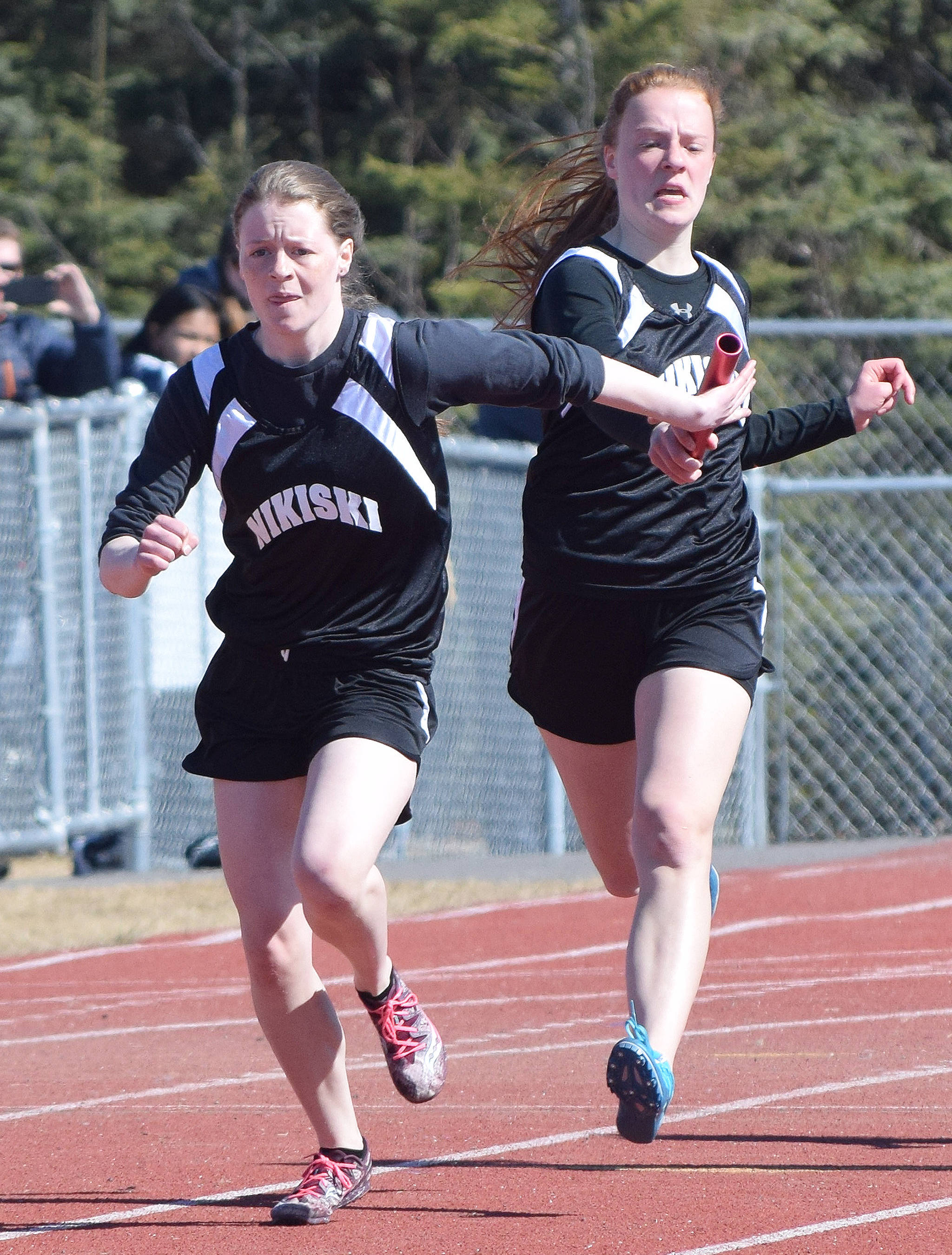 Nikiski sophomore Bailey Epperheimer (right) hands off to her sister Sidney Epperheimer Saturday afternoon in the girls 400-meter relay at the SoHi Region III Preview Invite at Justin Maile Field in Soldotna. (Photo by Joey Klecka/Peninsula Clarion)