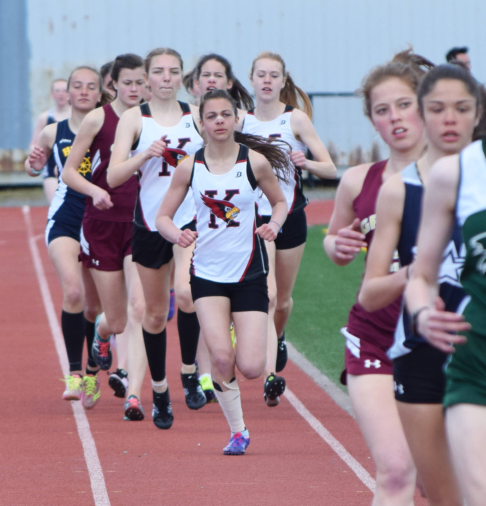 Kenai Central’s Summer Foster leads a trailing group of runners in the girls 1,600 meters Saturday, May 4, 2019, at the Kenai Invitational track meet at Kenai Central High School. (Photo by Joey Klecka/Peninsula Clarion)