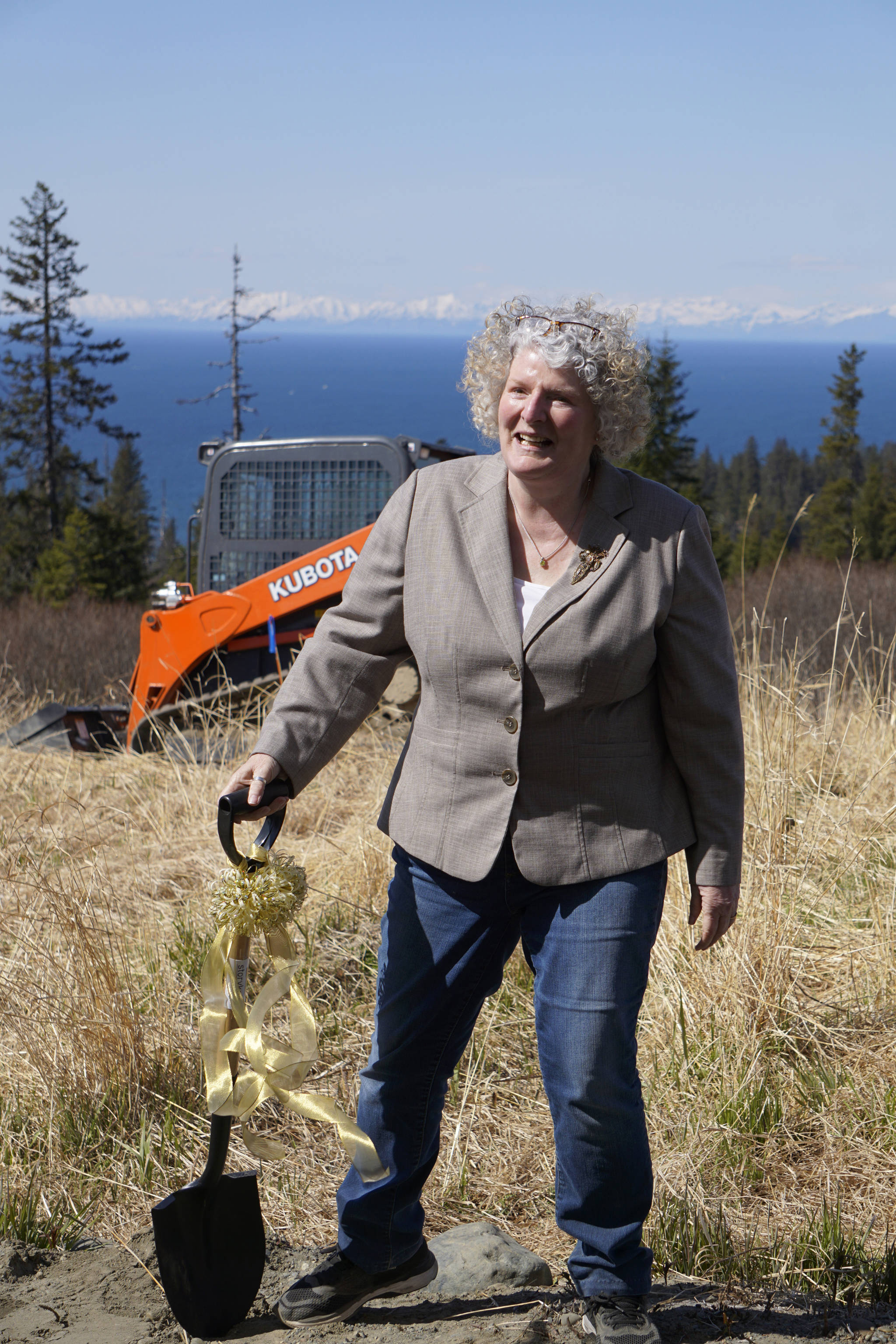 Building a dream Homer writer and Storyknife Writers Retreat founder Dana Stabenow turns the earth at groundbreaking ceremonies last Saturday, May 4, 2019, at the retreat property in Homer, Alaska. Construction started this month on the main house and cabins that will in a year house visiting women writers. (Photo by Michael Armstrong/Homer News)