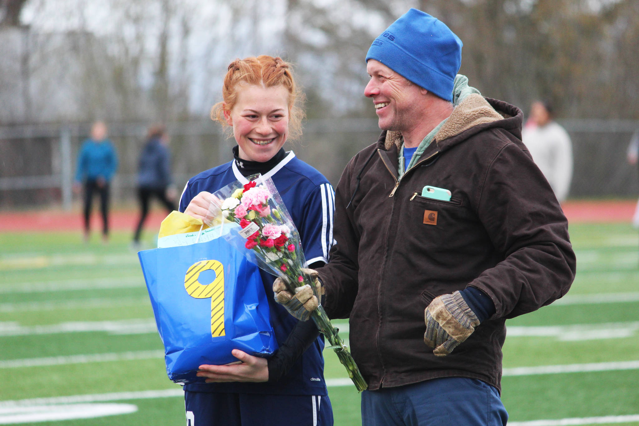 Forward and midfielder Sienna Carey stands with her father during a Senior Night recognition ceremony between the girls and boys soccer games Friday, May 10, 2019 at Homer High School in Homer, Alaska. (Photo by Megan Pacer/Homer News)