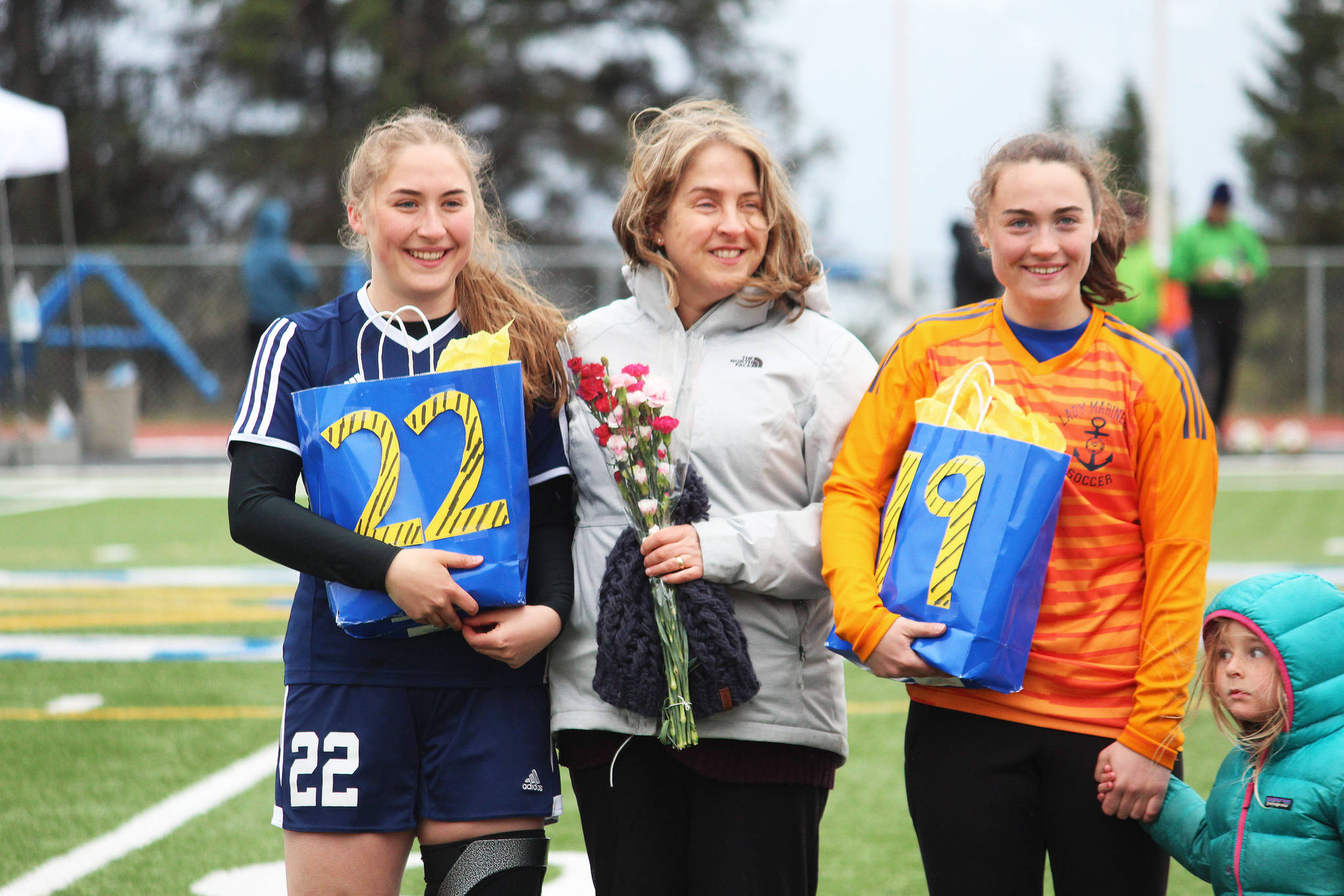 Brenna (left) and Alison (right) McCarron stand with their family members to be recognized on Senior Night between the boys and girls soccer games against Thunder Mountain on Friday, May 10, 2019 at Homer High School in Homer, Alaska. (Photo by Megan Pacer/Homer News)