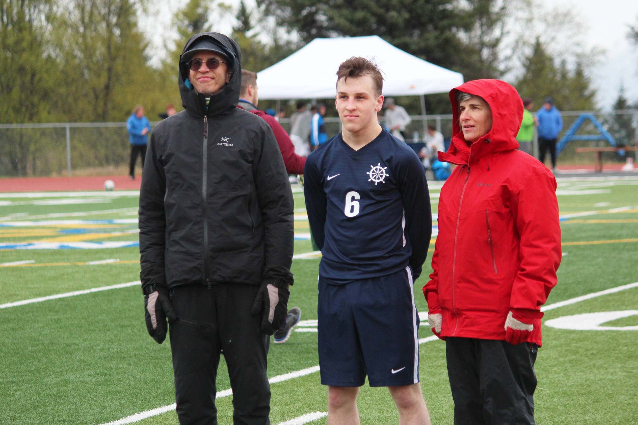 Forward Tom Gorman standing with his parents to be recognized during a Sneior Night celebration between the boys and girls soccer games held Friday, May 10, 2019 at Homer High School in Homer, Alaska. (Photo by Megan Pacer/Homer News)