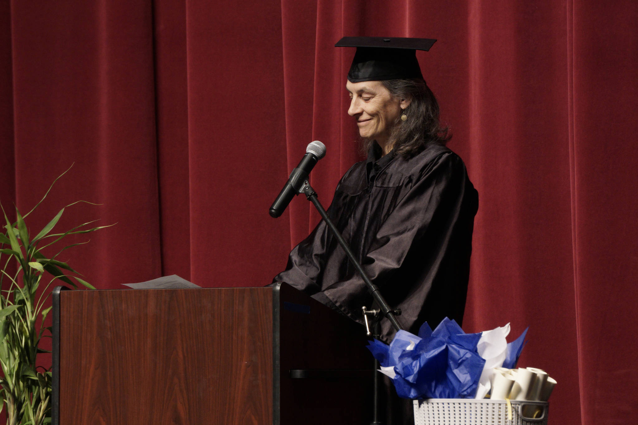 Catie Bursch delivers the keynote address at the Kachemak Bay Campus commencement last Wednesday, May 8, 2019, at the Mariner Theatre in Homer, Alaska. (Photo by Michael Armstrong/Homer News.)