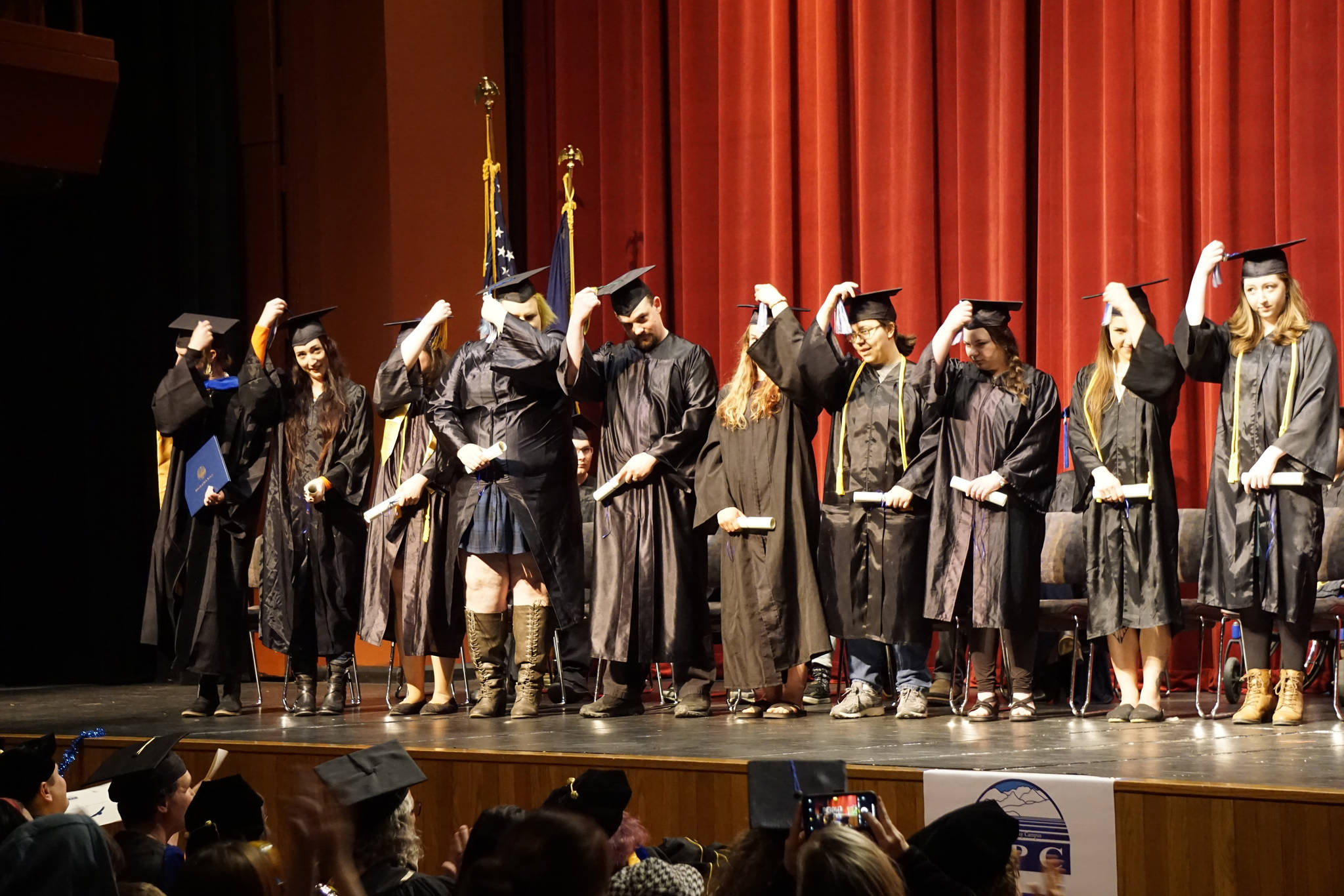 Graduates flip their tassels at the Kachemak Bay Campus commencement last Wednesday, May 8, 2019, at the Mariner Theatre in Homer, Alaska. (Photo by Michael Armstrong/Homer News.)