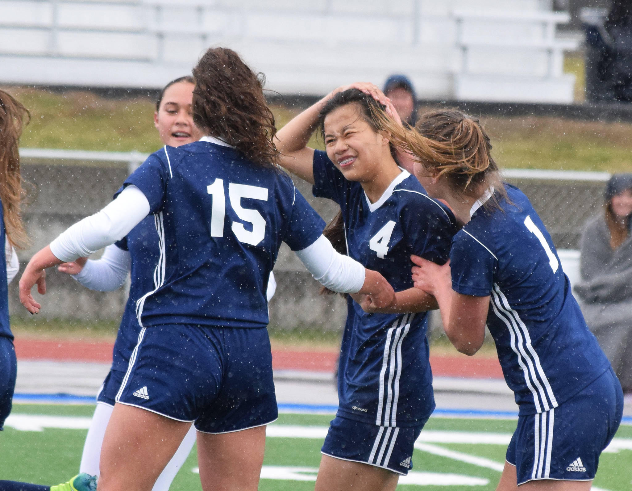 Soldotna’s Meijan Leaf (4) receives congratulations from teammates after scoring a goal against Homer on Saturday in a Peninsula Conference game in Soldotna. (Photo by Joey Klecka/Peninsula Clarion)
