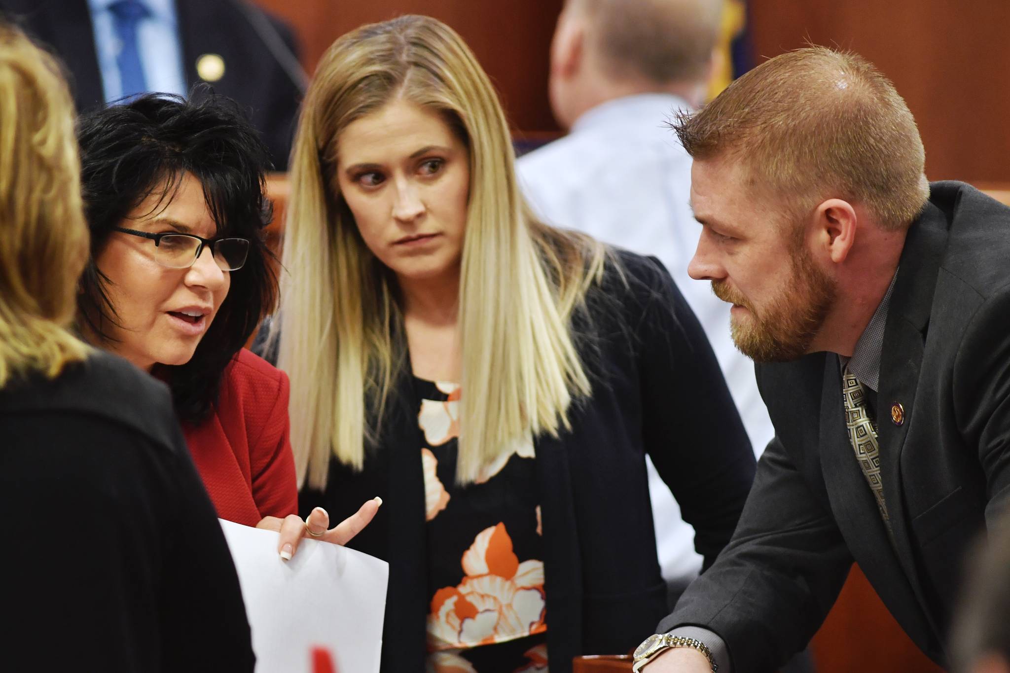 Rep. Cathy Tilton, R-Wasilla, left, speaks with Rep. Sara Rasmussen, R-Anchorage, and Rep. Josh Revak, R-Anchorage, on the House floor as amendments to the budget are proposed on Tuesday, April 9, 2019 in Juneau, Alaska. (Michael Penn | Juneau Empire)