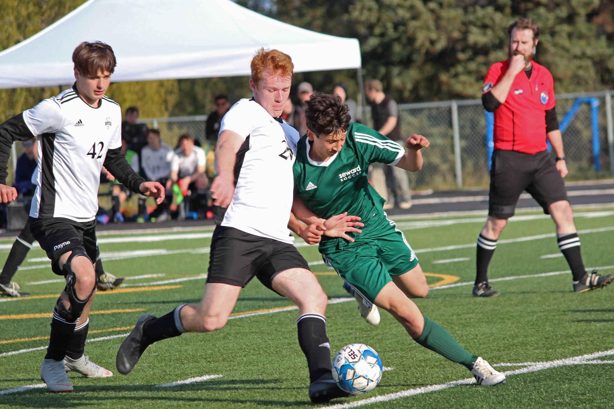 Nikiski’s Jace Kornstad (left) and Seward’s John Moriarty (right) battle for the ball during the first boys game of the Peninsula Conference Soccer Tournament held Thursday, May 16, 2019 at Homer High School in Homer, Alaska. (Photo by Megan Pacer/Homer News)
