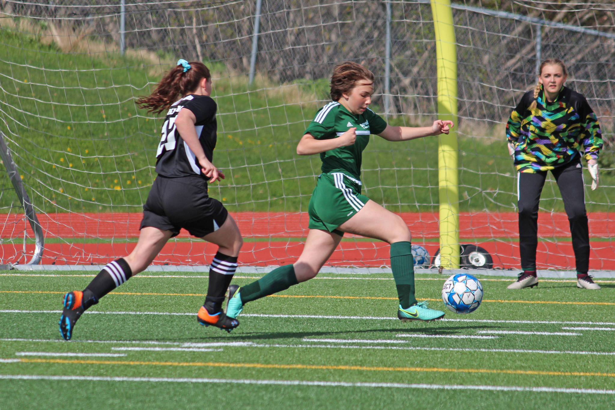 Seward’s Mikya Wallace steals the ball from Nikiski’s Tawnisha Freeman before she can make a shot during the first girls game of the Peninsula Conference Soccer Tournament on Thursday, May 16, 2019 at Homer High School in Homer, Alaska. (Photo by Megan Pacer/Homer News)