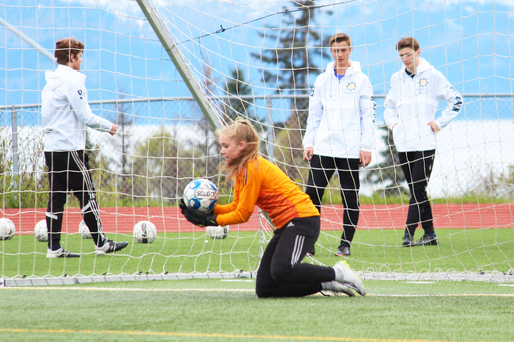 Homer’s Paige Jones saves a penalty kick from Soldotna during the girls championship game of the Peninsula Conference Soccer Tournament on Saturday, May 18, 2019 at Homer High School in Homer, Alaska. (Photo by Megan Pacer/Homer News)