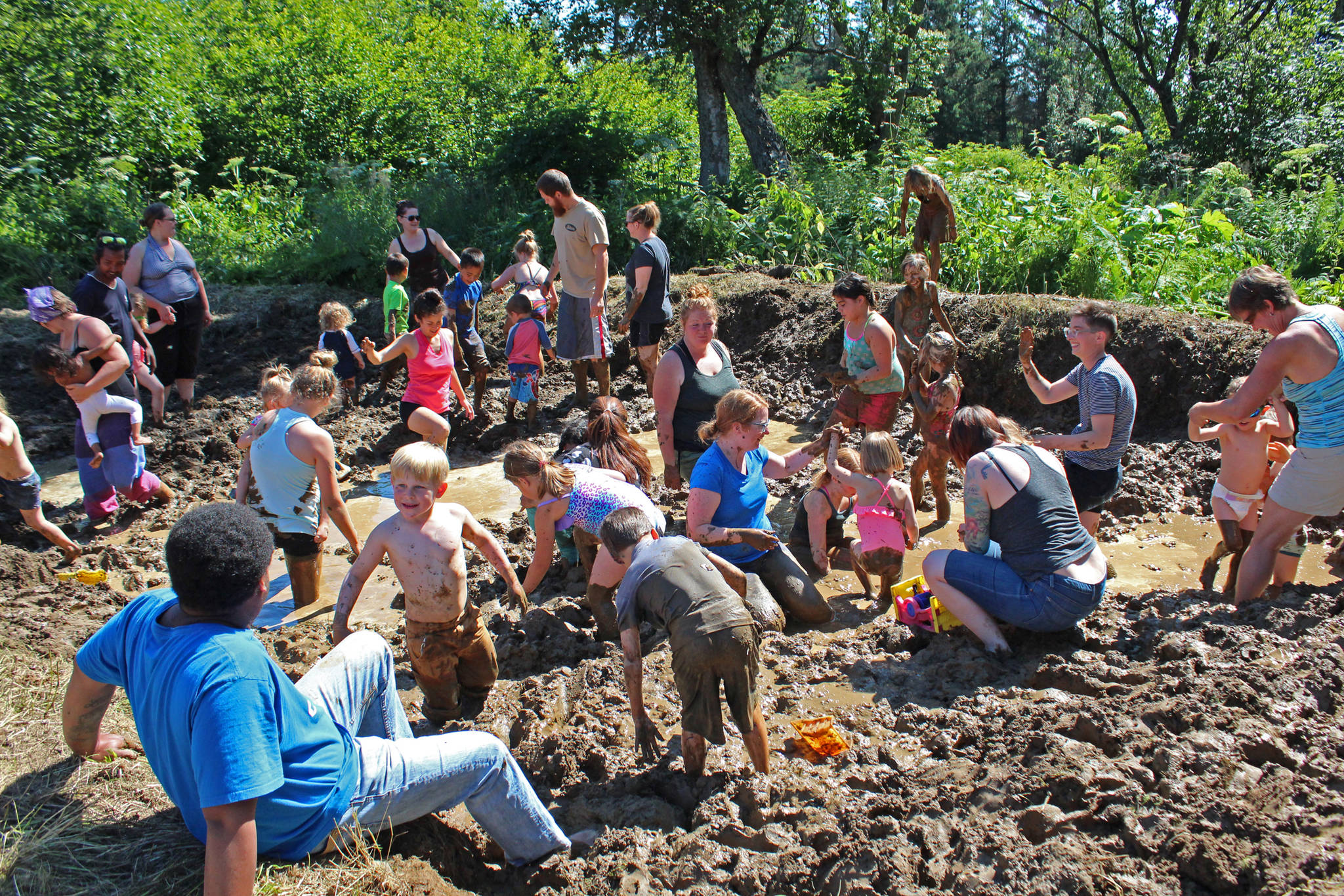 Kids and parents wade through copious amounts of mud in a pit specially prepared for this year’s Mud Wallow on Saturday, July 22, 2017 at Cottonwood Horse Park in Homer, Alaska. (Homer News file photo)