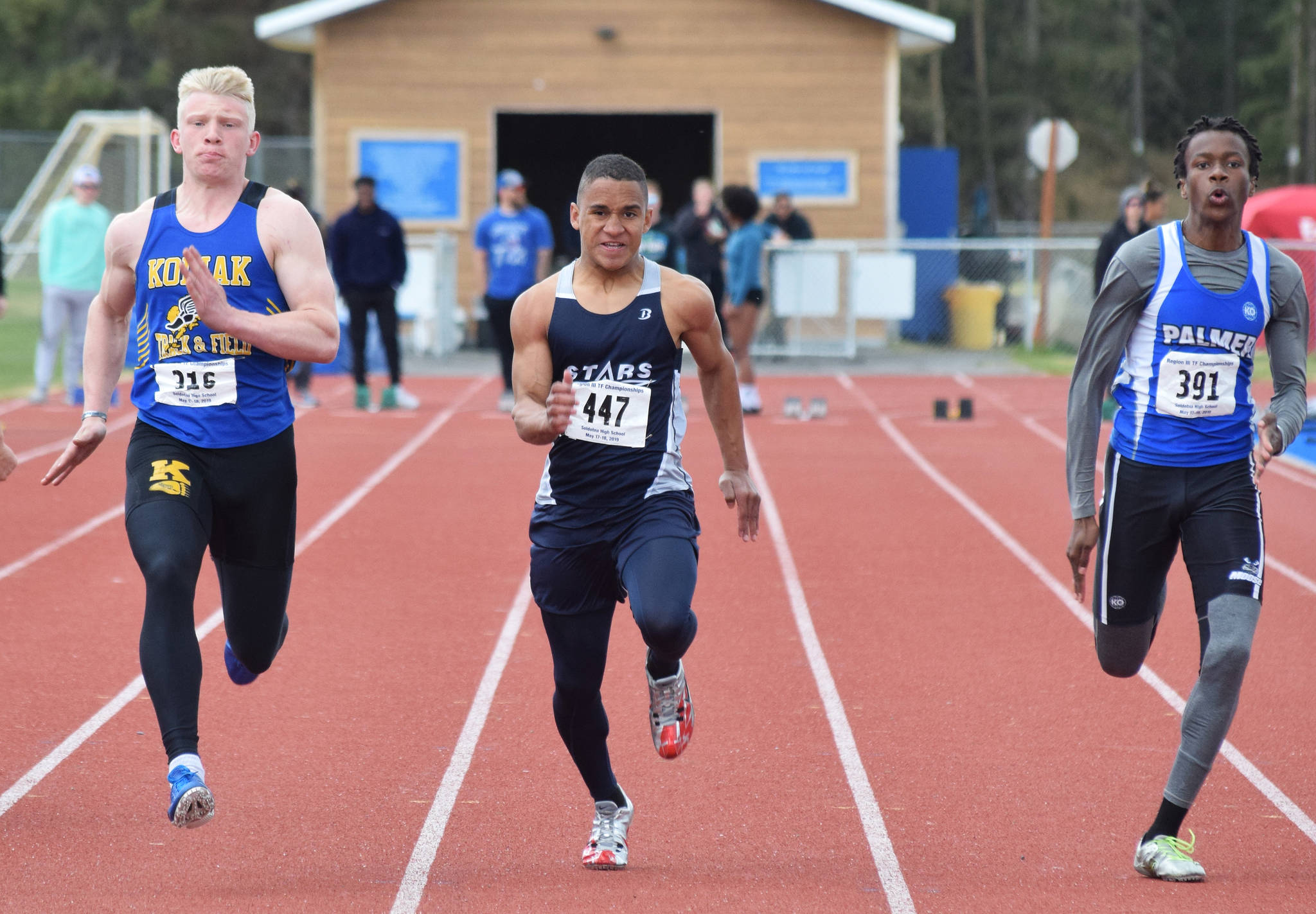 Soldotna’s Ben Booth (middle) races in the Class 4A boys 100-meter final Saturday at the Region III Track and Field Championships in Soldotna. (Photo by Joey Klecka/Peninsula Clarion)