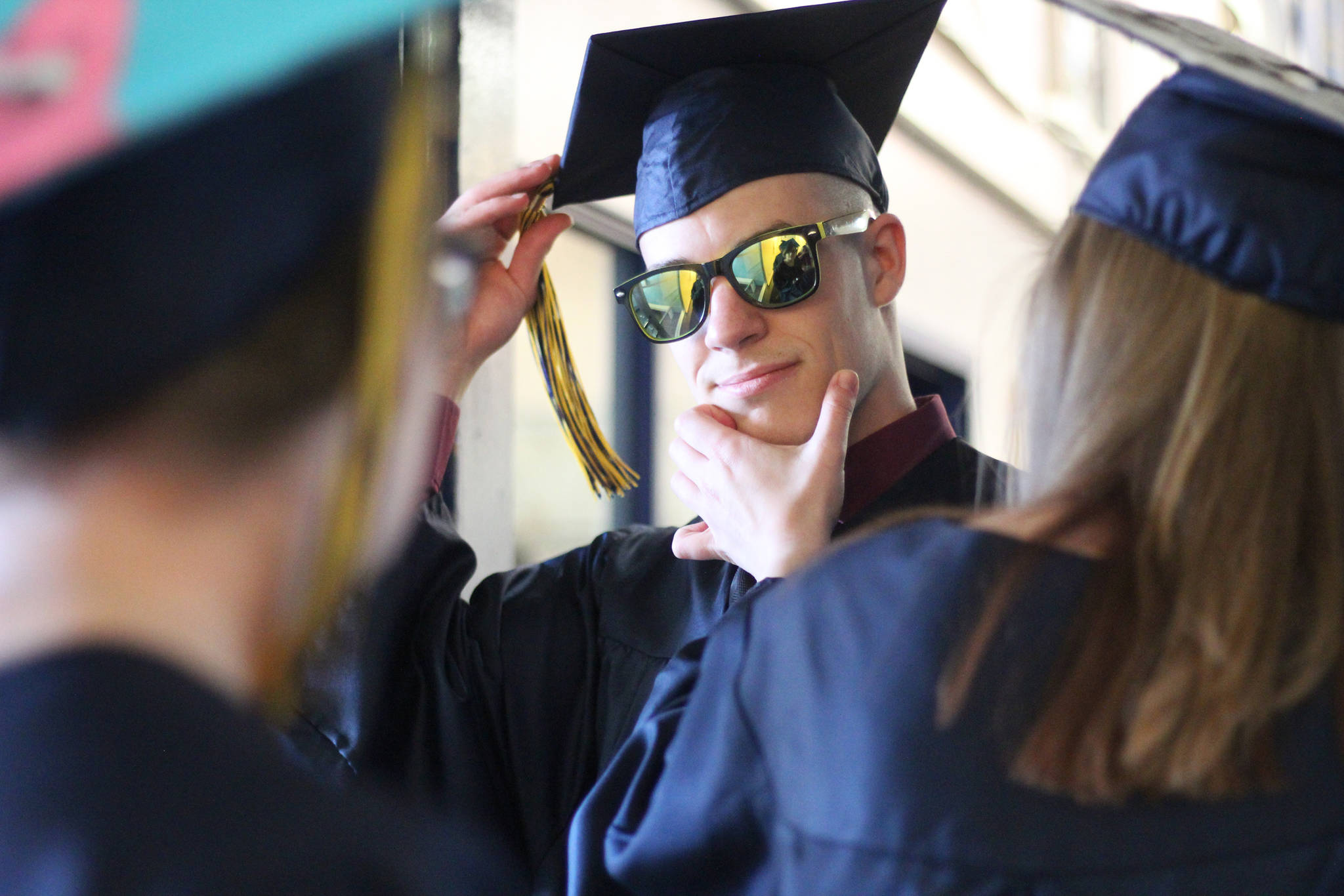 Isabella Koch helps Garrett Koch perfect the finishing touches before they walk in their graduation ceremony Tuesday, May 21, 2019 at Ninilchik School in Ninilchik, Alaska. They are two of four total Ninilchik graduates this year. (Photo by Megan Pacer/Homer News)