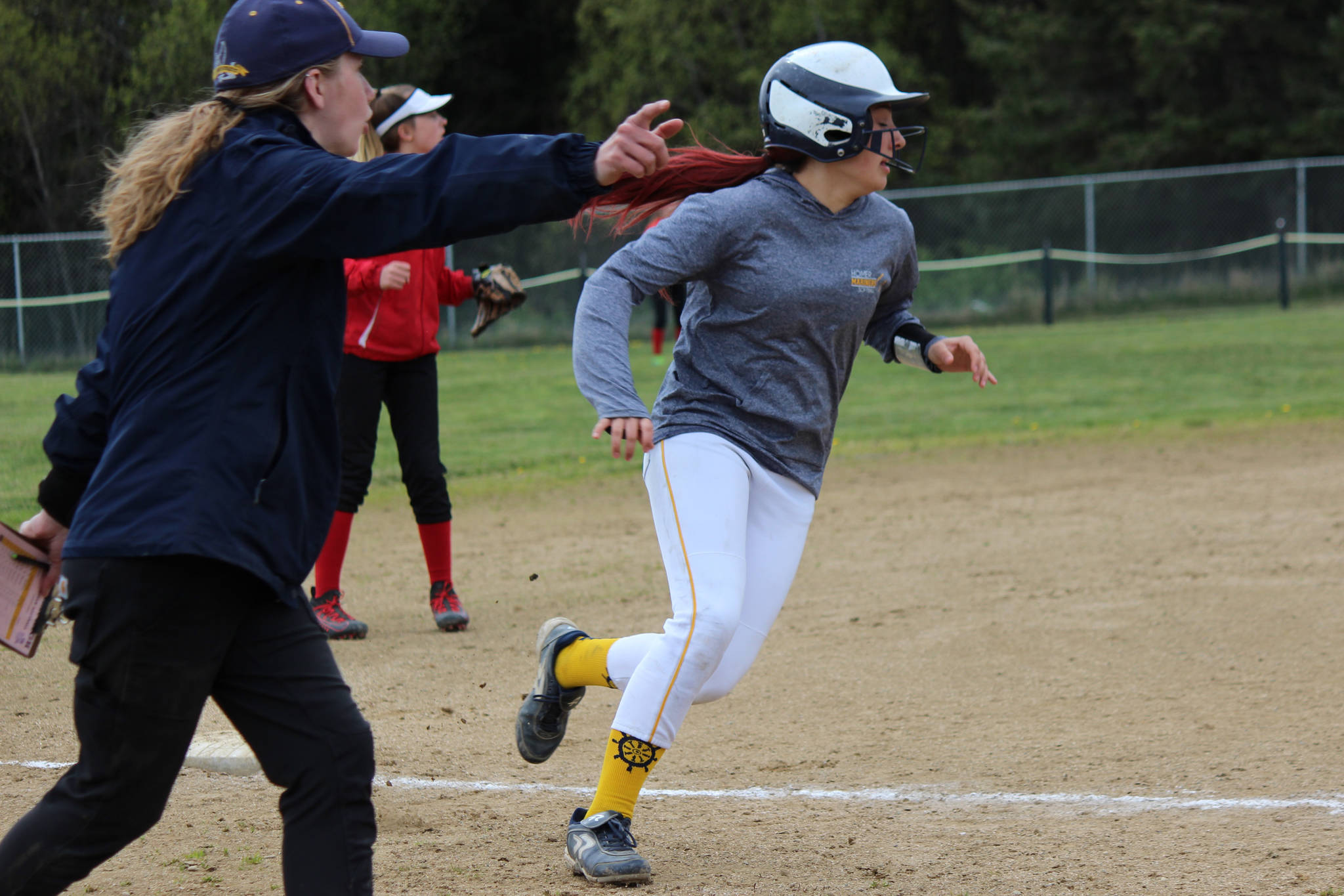 Mariner Haylee Owen rounds third base and keeps on going as Assistant Coach Hannah Zook directs her toward home plate.