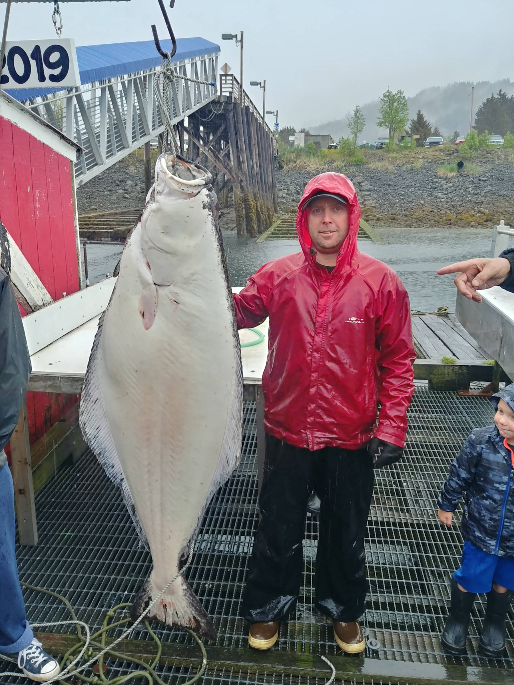 Steve Pollack IV poses on May 26, 2019, with a 133-pound halibut, the largest halibut caught in the Seldovia Human Powered Fishing Derby held in Seldovia, Alaska, over the Memorial Day weekend. Pollack caught the halibut fishing from a 13-foot rowboat. (Photo provided)
