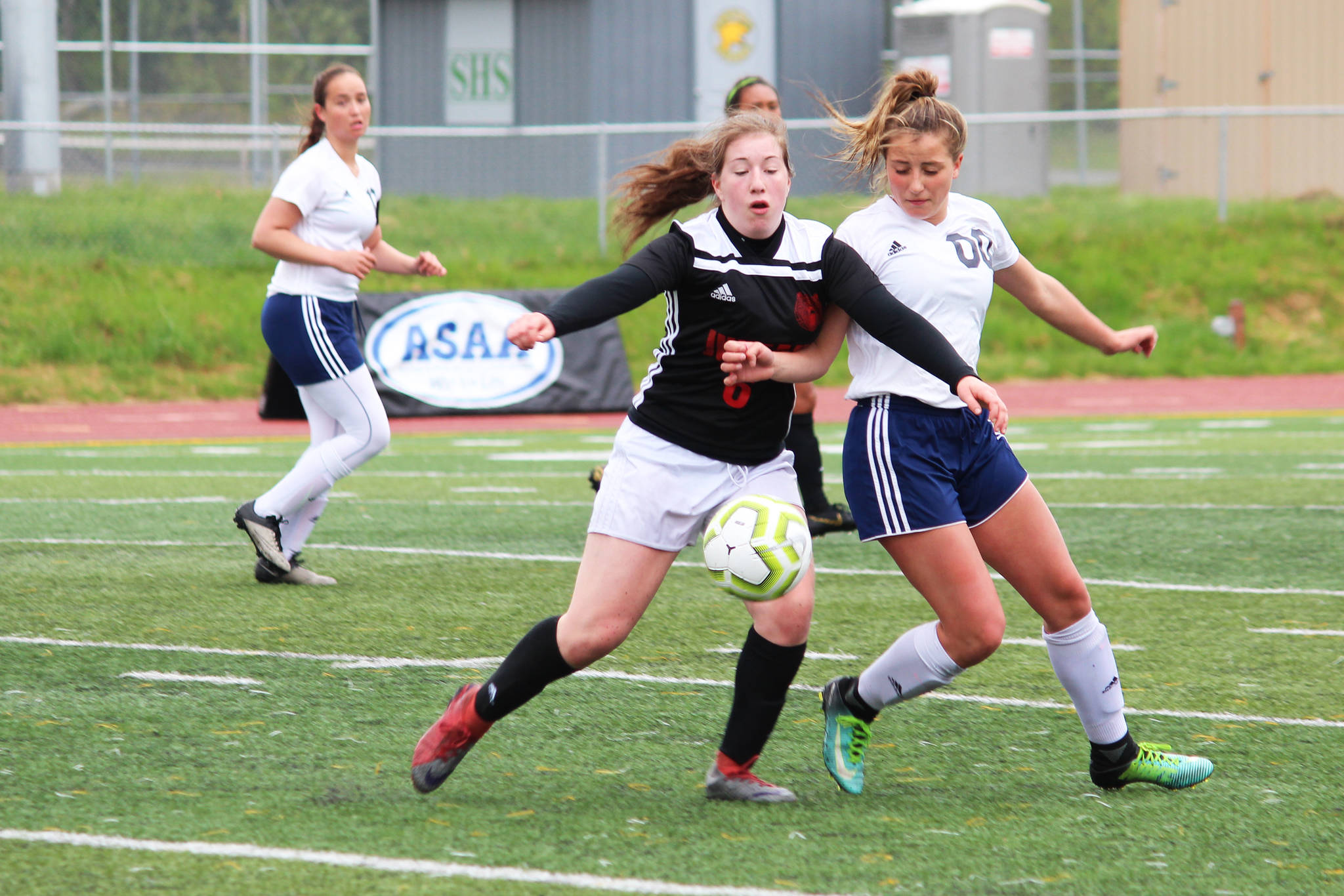 Juneau’s Eva Goering (left) and Soldotna’s Ryann Cannava battle for the ball during the final game of the Division II state soccer championships Saturday, May 25, 2019 at Service High School in Anchorage, Alaska. (Photo by Megan Pacer/Homer News)