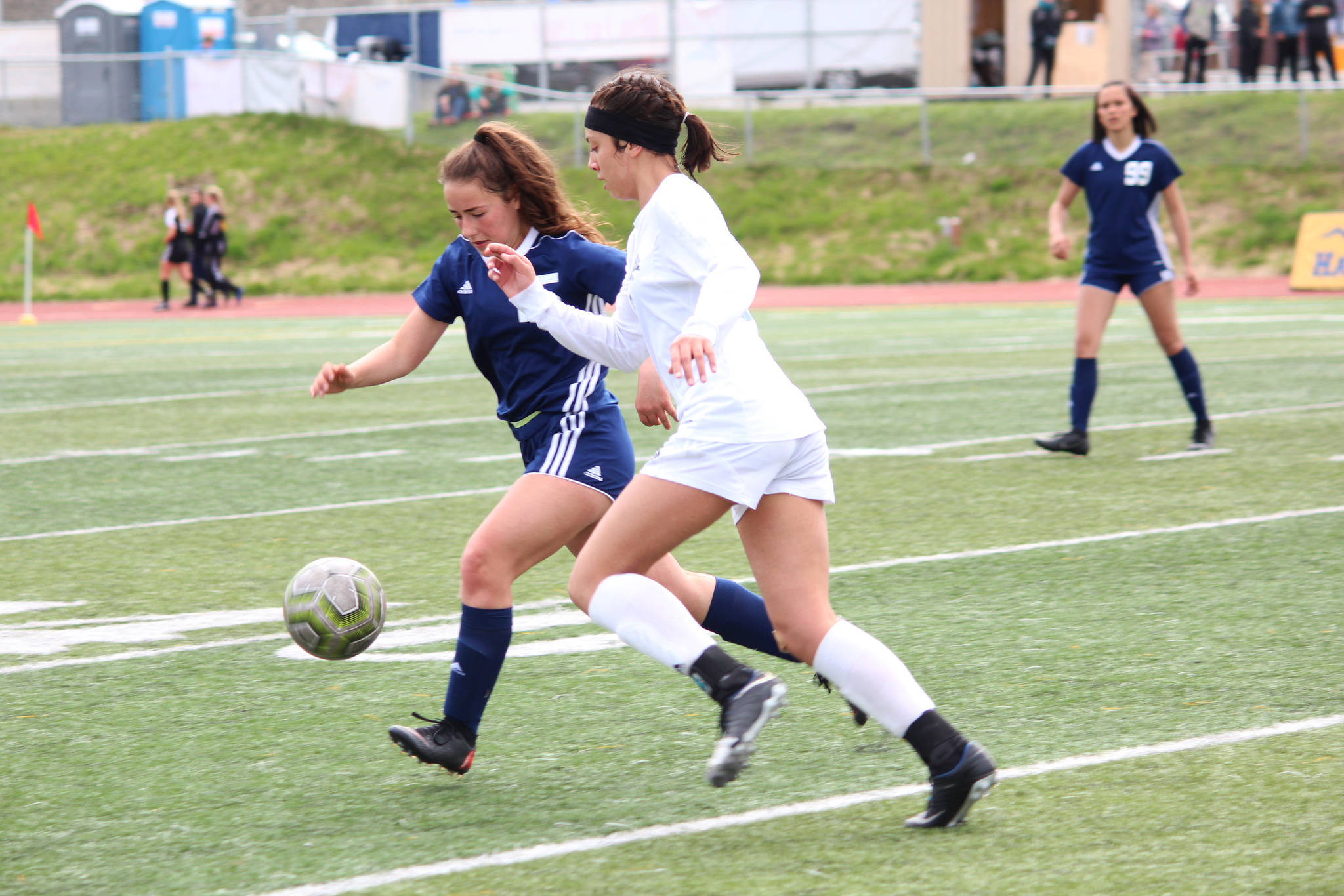 Soldotna’s Katherine Bramante and Thunder Mountain’s Keana Villanueva race to the ball during a semifinal game at the Division II state soccer championships Friday, May 24, 2019 at Service High School in Anchorage, Alaska. (Photo by Megan Pacer/Homer News)