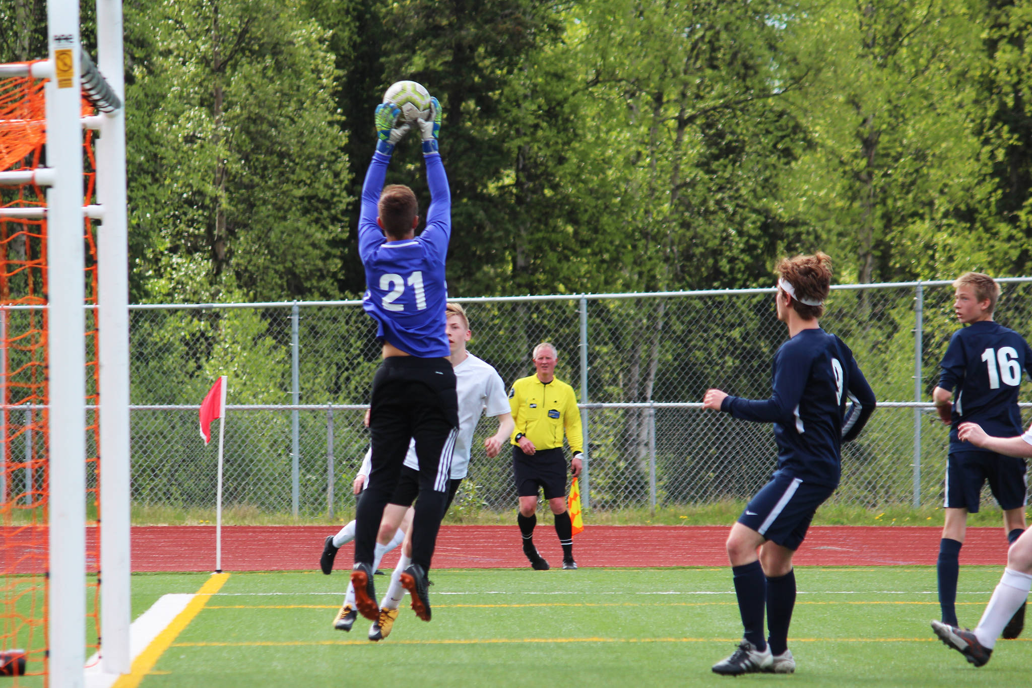 Honer goalkeeper Clayton Beachy makes a save against Grace Christian School in a Friday, May 24, 2019 game during the Division II state soccer championship tournament at Eagle River High School in Eagle River, Alaska. (Photo by Megan Pacer/Homer News)