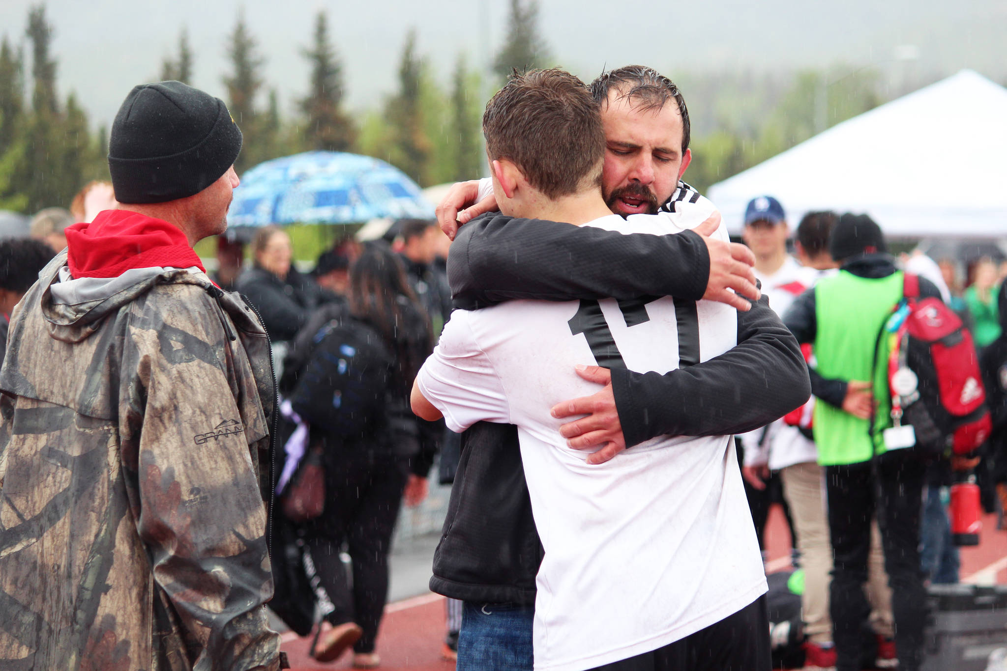 Kenai boys soccer team head coach Shane Lopez hugs player Travis Verkuilen as they celebrate their win over Juneau in the Saturday, May 25, 2019 final game of the Division II state soccer championships at Service High School in Anchorage, Alaska. (Photo by Megan Pacer/Homer News)